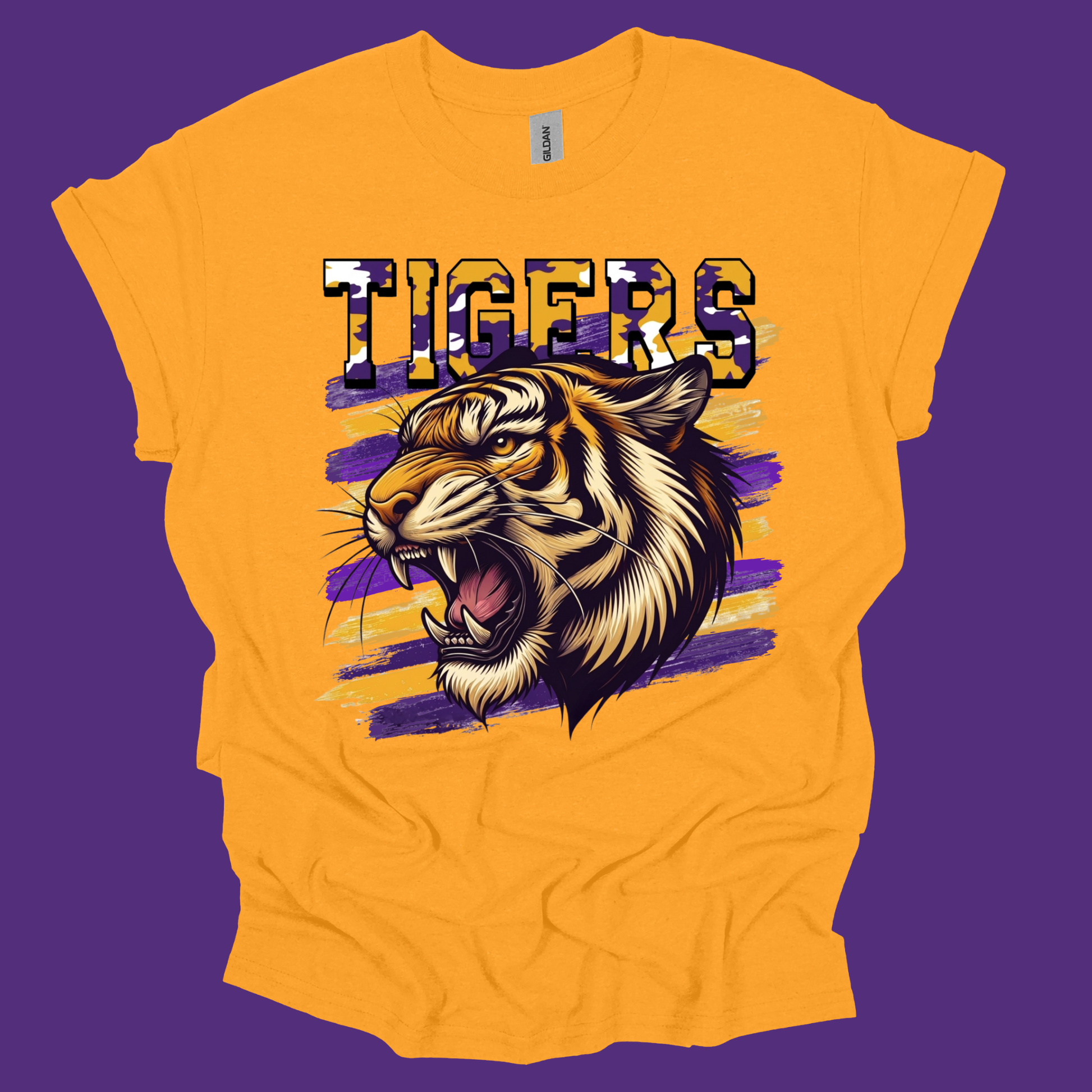 A bright yellow short-sleeve t-shirt with a graphic of a roaring tiger and the word 'TIGERS' in a patterned font, set against a solid purple background.
