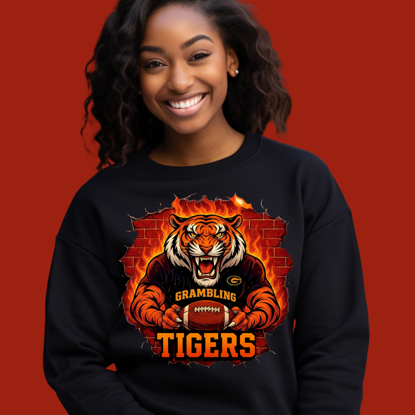 Person wearing a black sweatshirt with a tiger graphic and 'Grambling Tigers' text on a red background