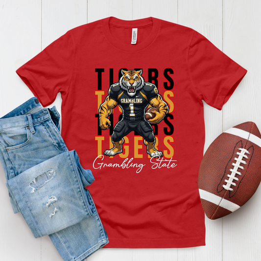 Red t-shirt with a tiger graphic and 'Grambling State' text, paired with jeans and a football on a white background. GSU Tigers T-Shirt – Grambling State University Game Day & Homecoming Graphic Tee