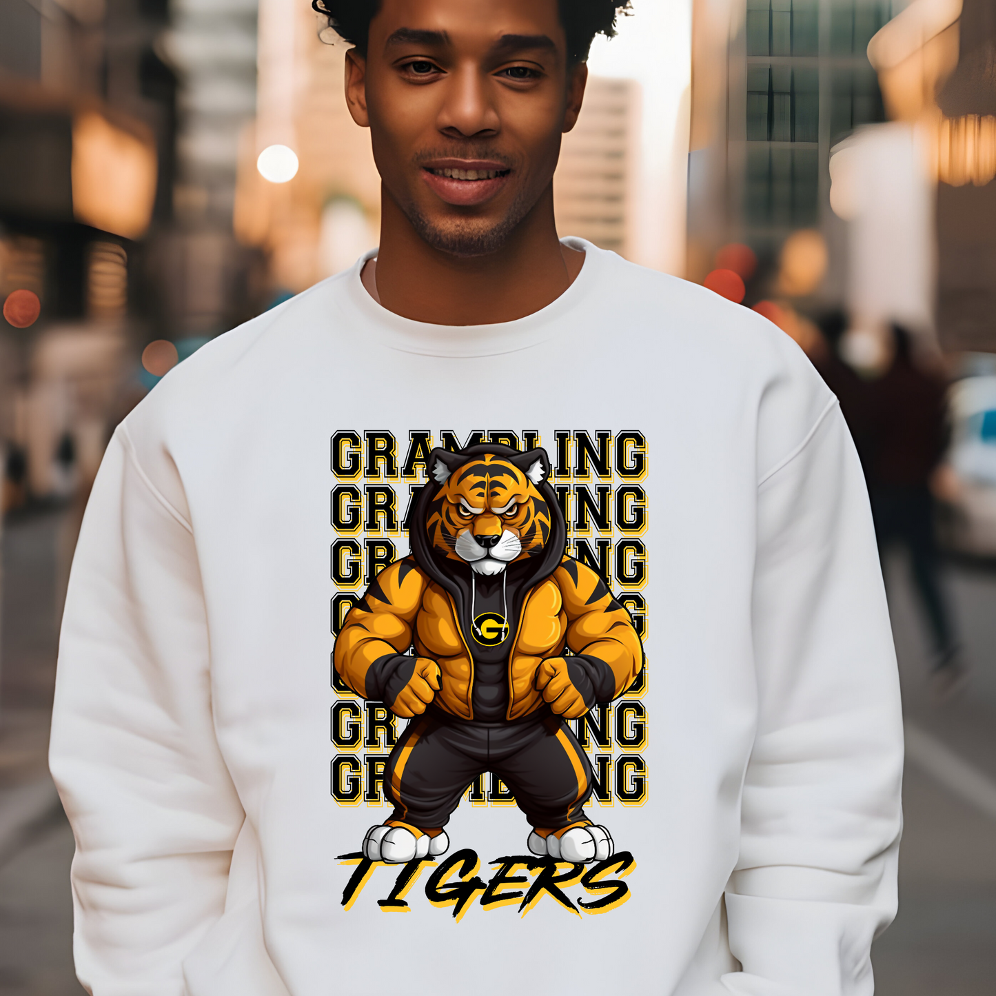 Person wearing a white sweatshirt with a tiger graphic and 'Grambling Tigers' text on a city street background.