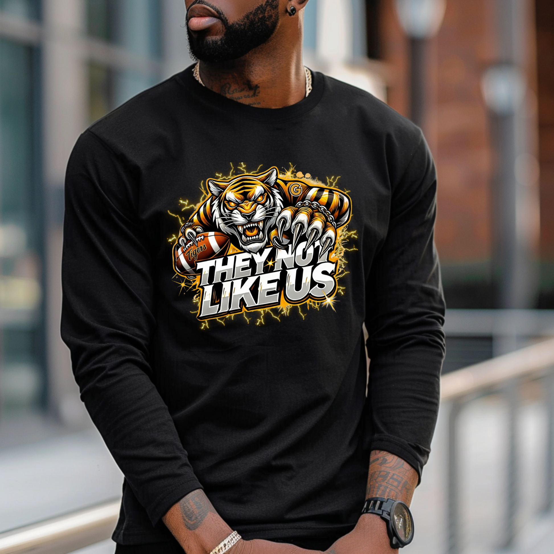 Person wearing a black long-sleeve shirt with a tiger graphic and text outdoors.