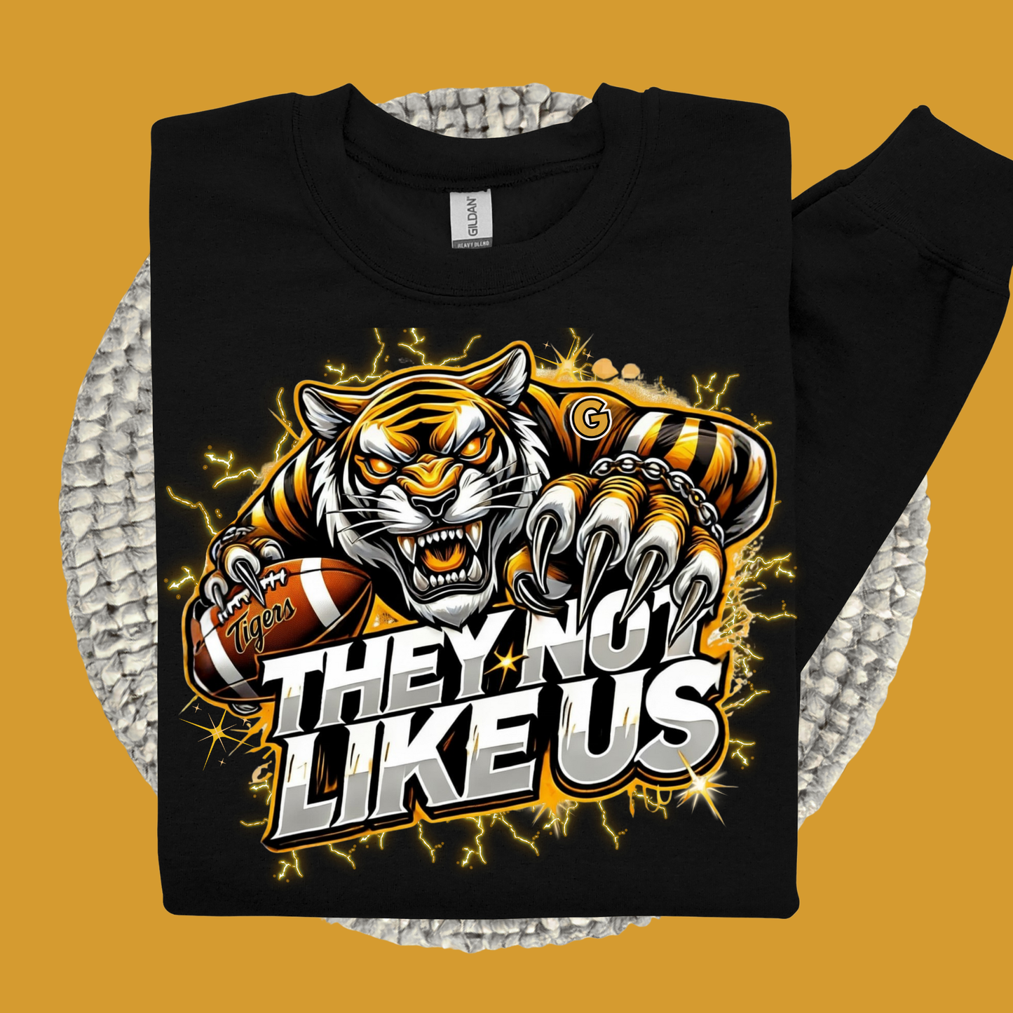 Black sweatshirt with a tiger graphic and text 'THEY NOT LIKE US' on a yellow background