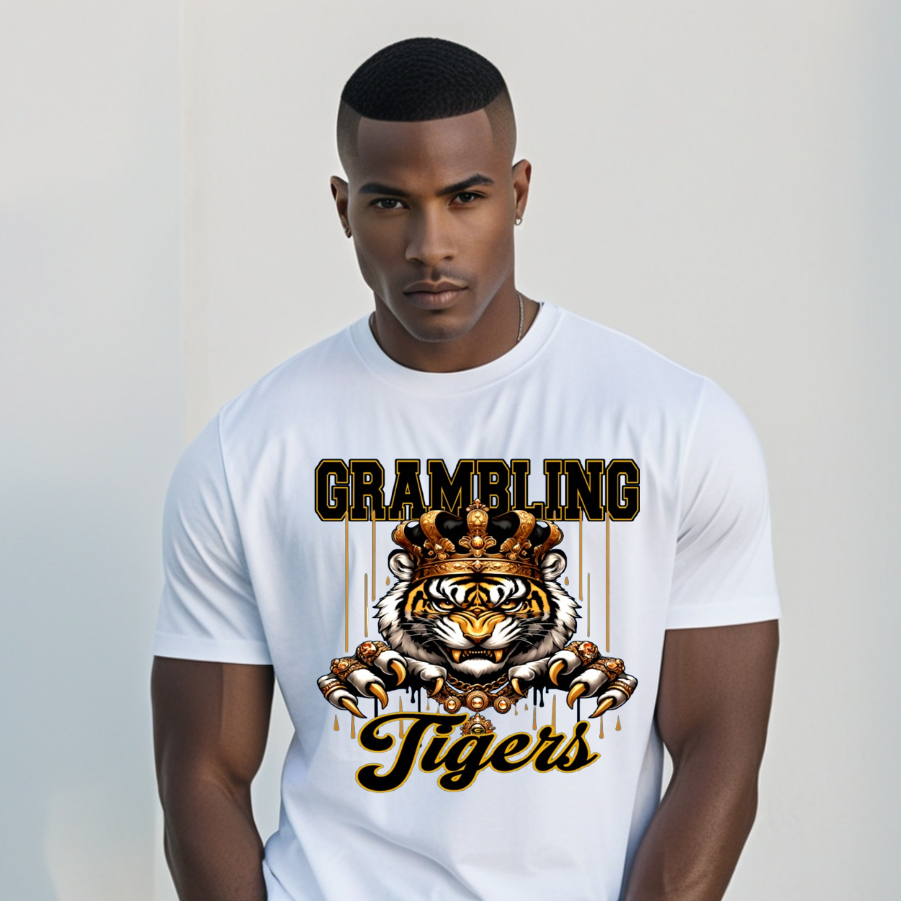 A man wearing a white short-sleeve t-shirt with a graphic print featuring a tiger and the text 'GRAMBLING Tigers' in black and gold.