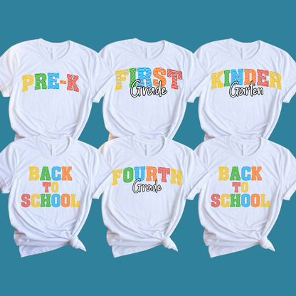 Six white graphic T-shirts arranged in two rows on a teal background, each printed with colorful school-themed text: PRE-K, FIRST Grade, KINDER Garden, BACK TO SCHOOL, FOURTH Grade, and BACK TO SCHOOL.