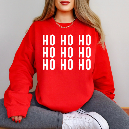 Red sweatshirt with 'HO HO HO' text worn by a person sitting on a chair.