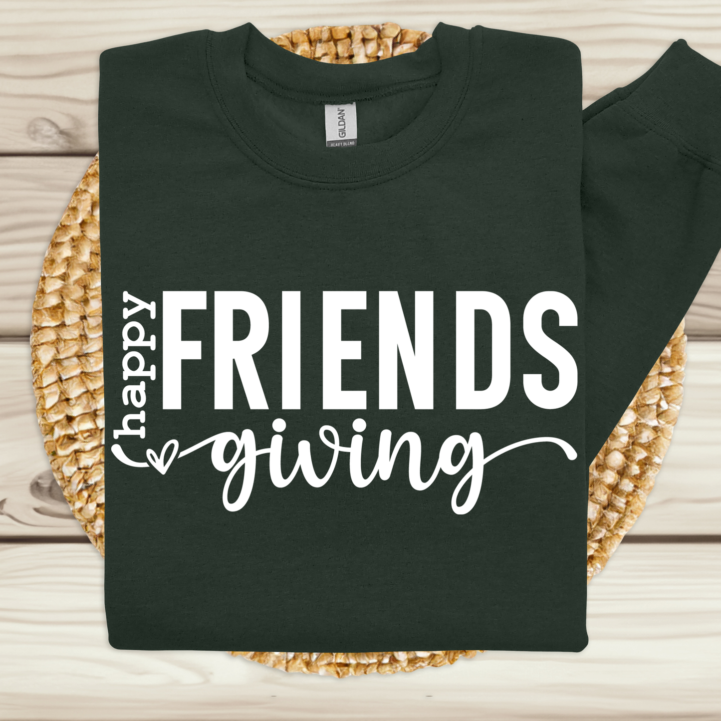 Black sweatshirt with 'happy friends giving' text on a woven mat