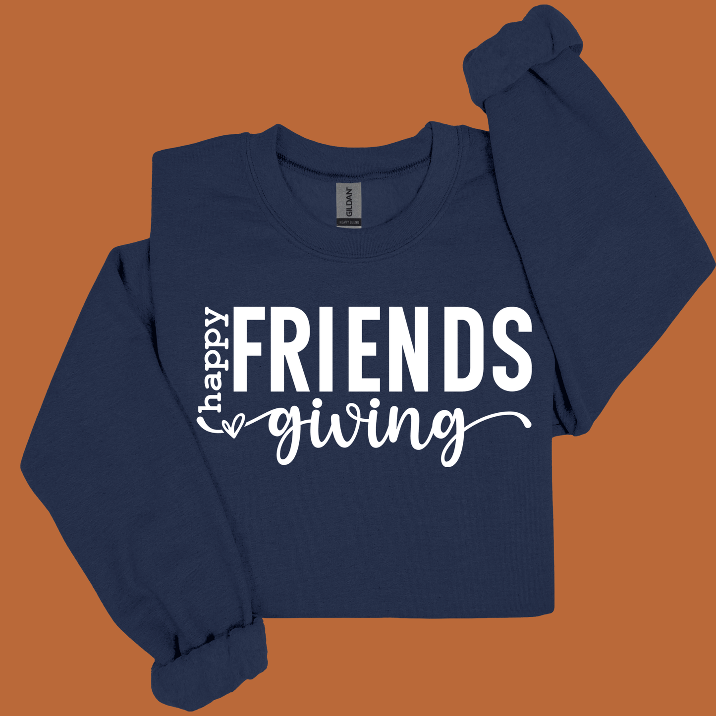 Navy blue long-sleeve shirt with 'Happy Friendsgiving' text on a brown background