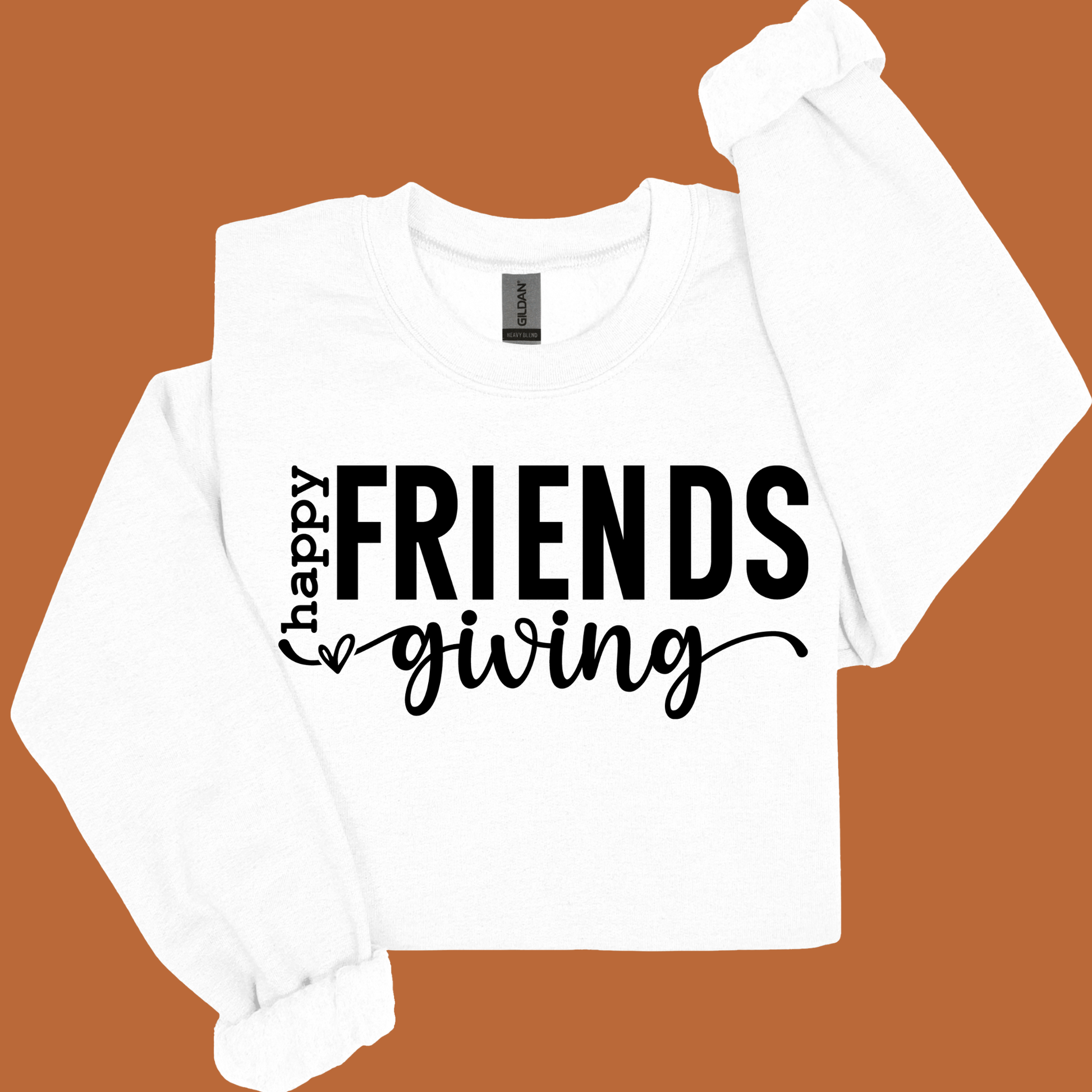 White long-sleeve shirt with 'Happy Friendsgiving' text on a brown background