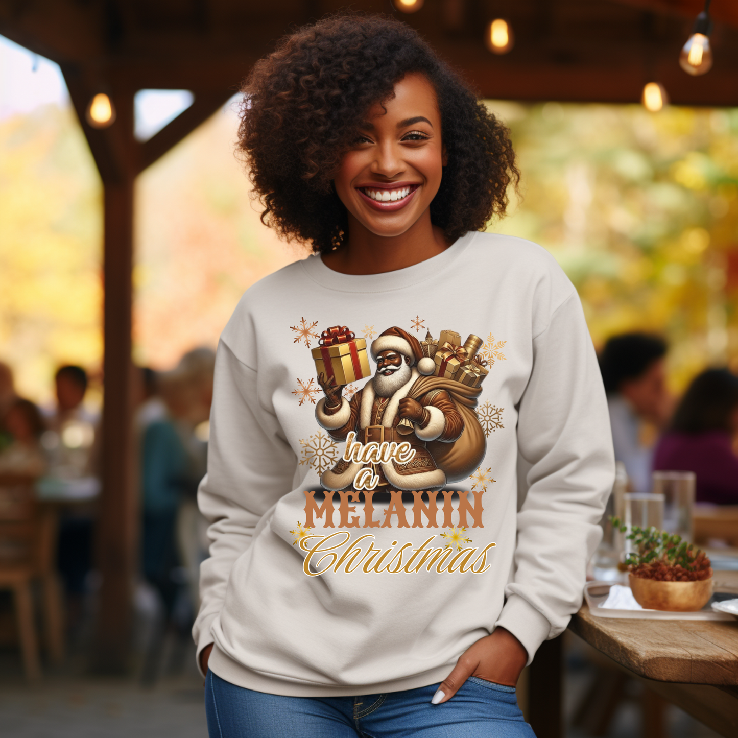 Woman wearing a sweatshirt with a festive design and text, standing outdoors.