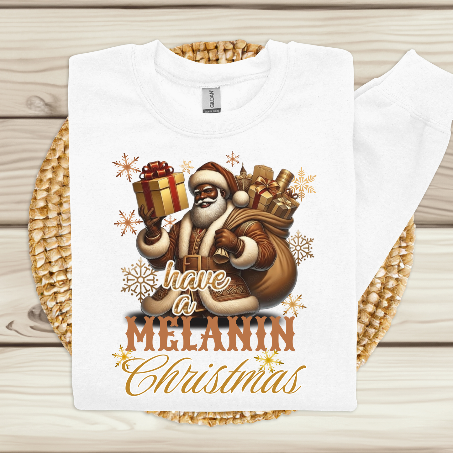 White t-shirt with a festive design featuring Santa Claus and text on a wooden surface