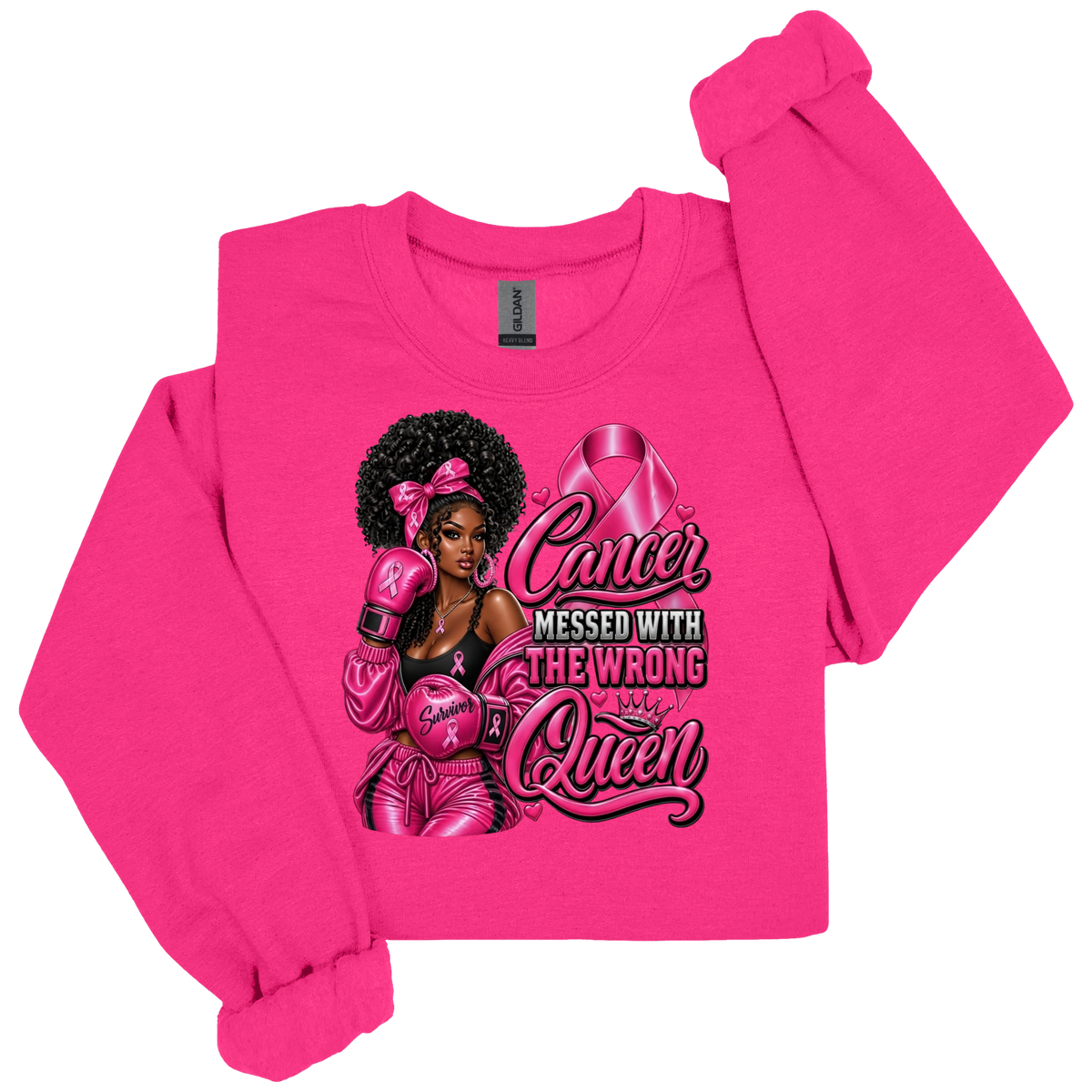 A bright pink crewneck sweatshirt with a graphic print of a Black woman in boxing gear wearing pink boxing gloves and a pink headband, alongside a pink breast cancer ribbon and the text 'Cancer Messed With The Wrong Queen'.