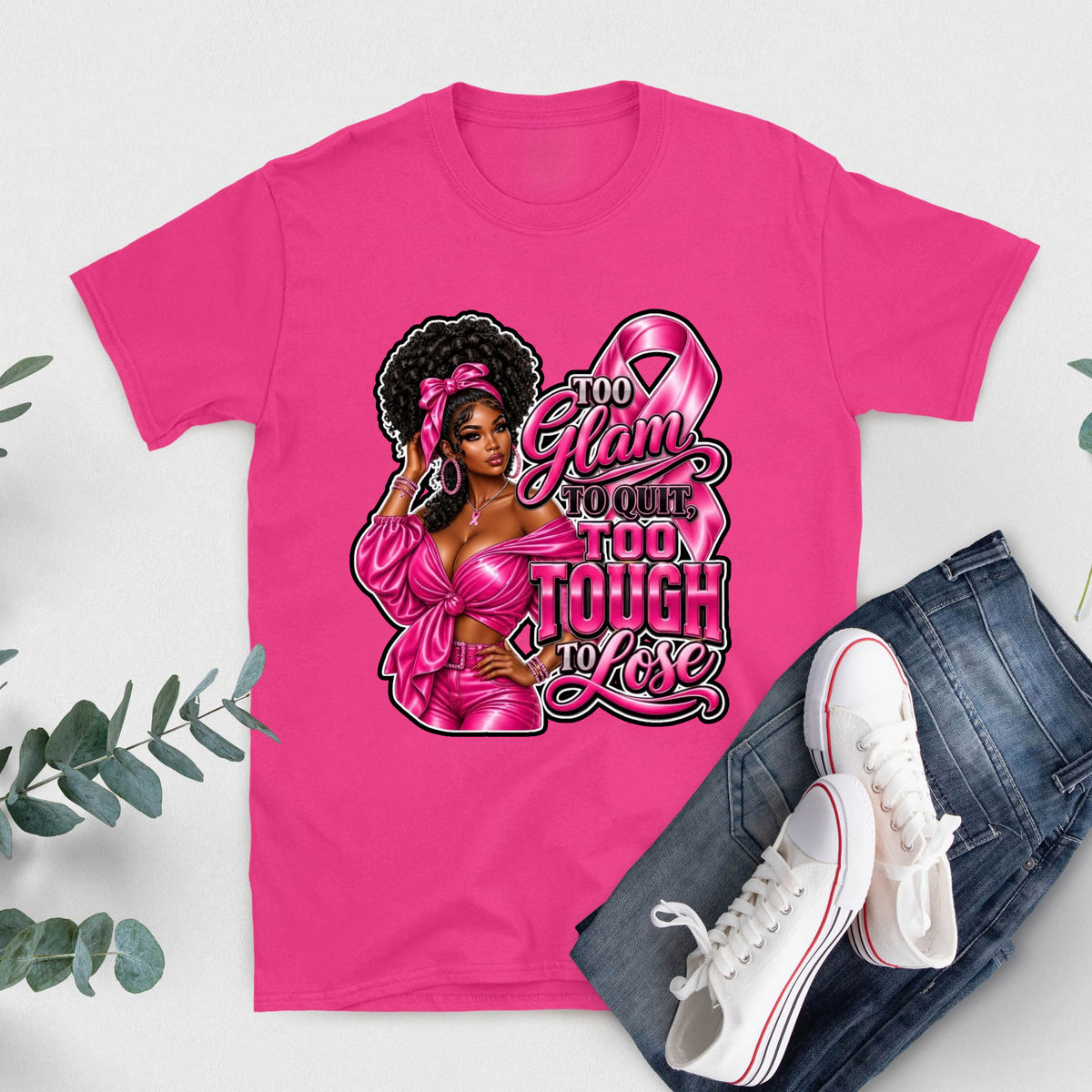 A bright pink short-sleeve T-shirt with bold white text reading 'FIGHT LIKE A QUEEN' laid flat on a light background, styled with blue jeans and white sneakers.