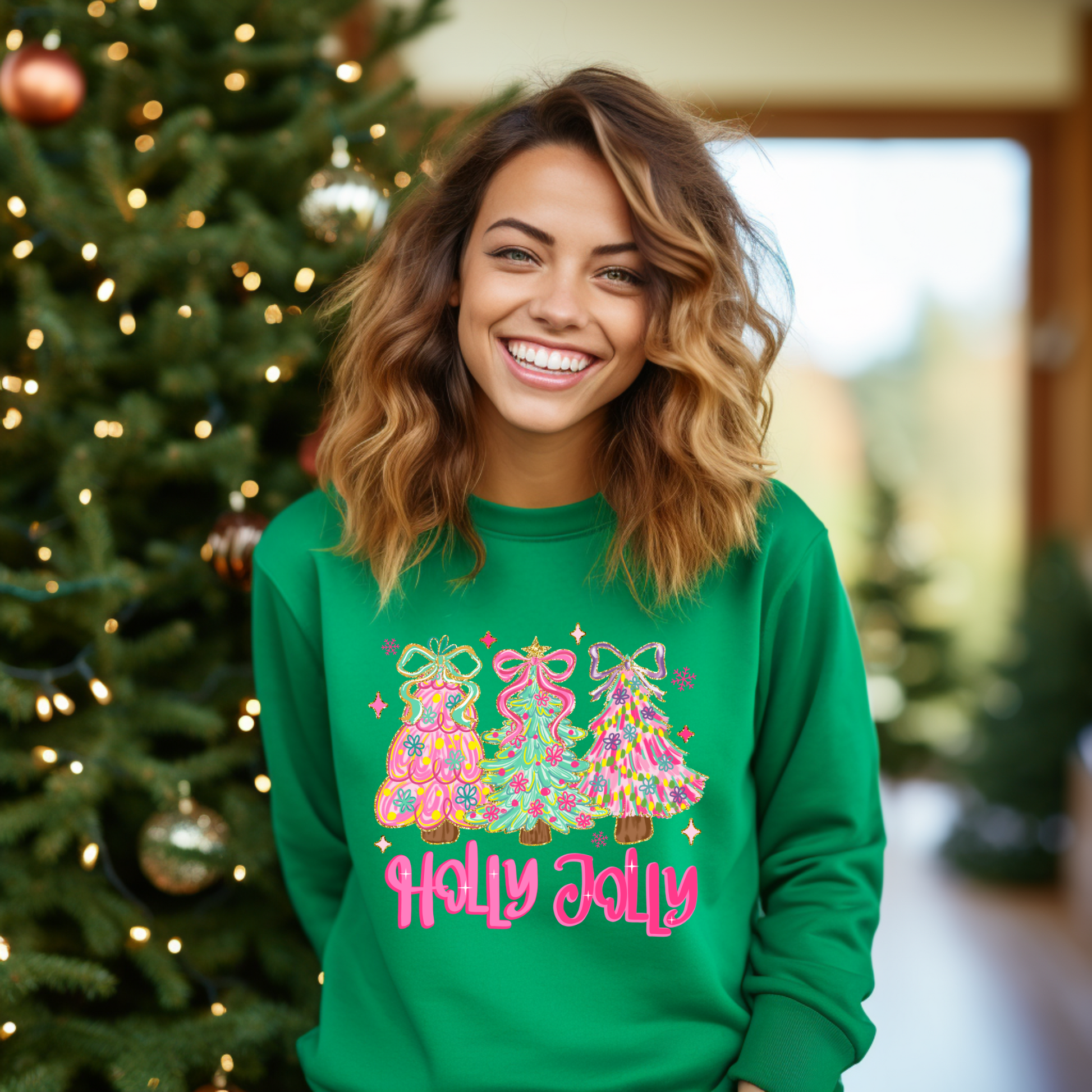 Woman wearing a green 'Holly Jolly' sweater in front of a decorated Christmas tree.