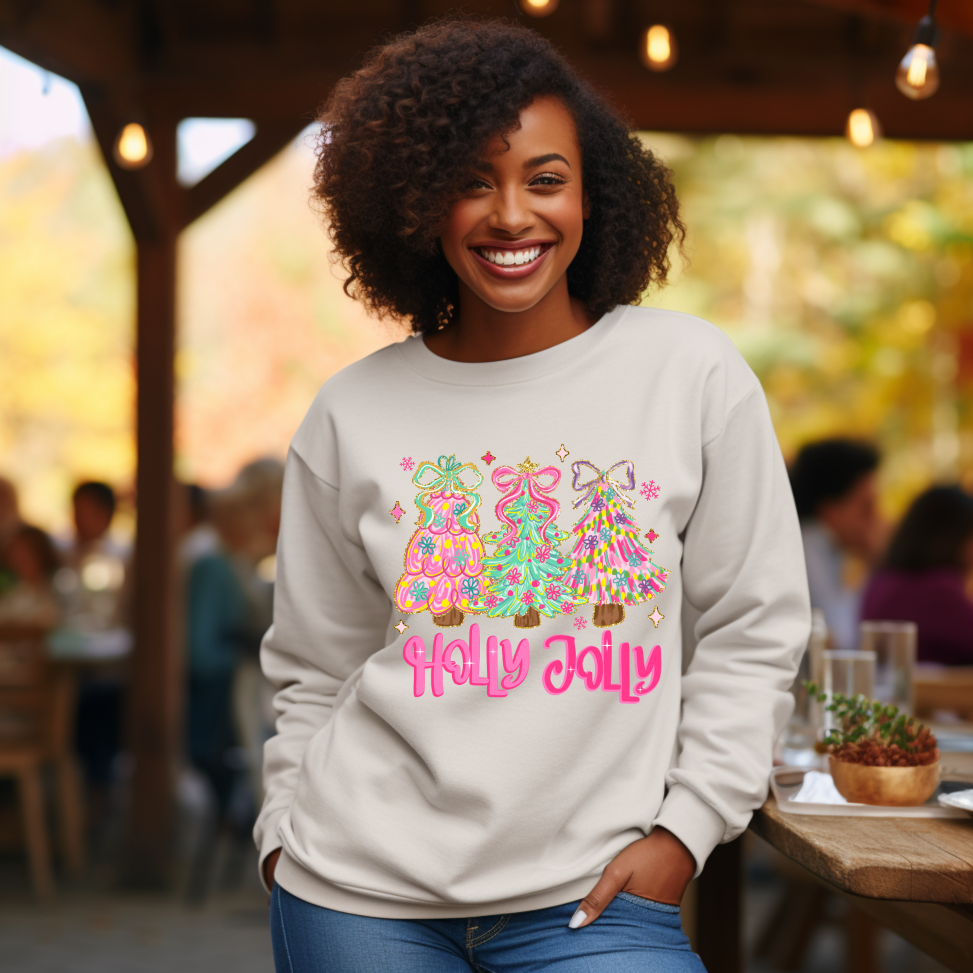 Woman wearing a 'Holly Jolly' sweater with colorful designs in an outdoor setting.