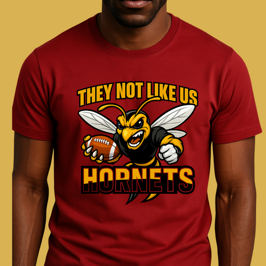 Red t-shirt with a hornet graphic and text on a yellow background Hornets Mascot Shirt - Bold Hornets They Not Like Us Game Day Spirit Tee
