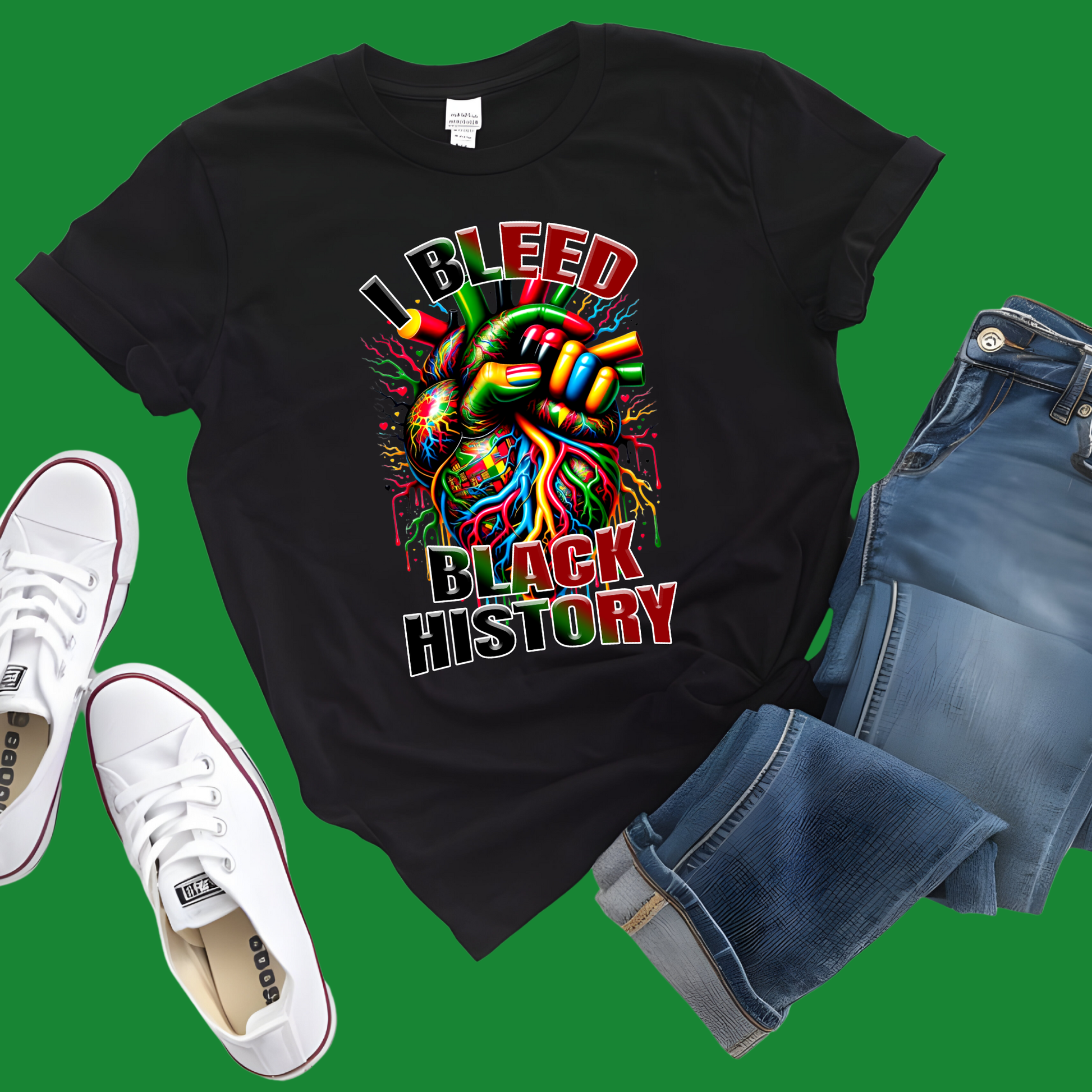 Black t-shirt with colorful graphic and text 'I BLEED BLACK HISTORY', white sneakers, and blue shorts on a green background.