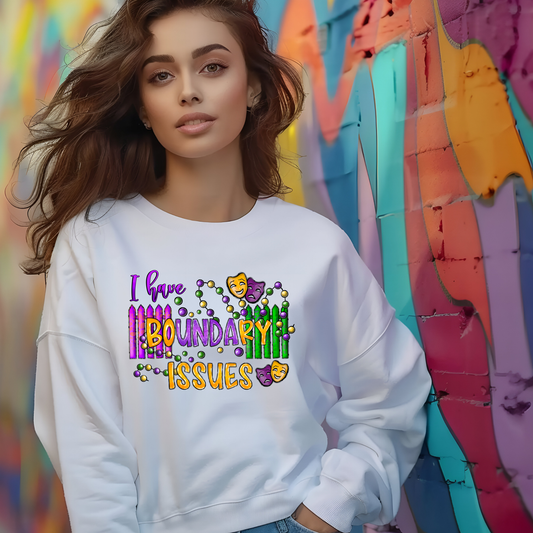 Person wearing a white sweatshirt with colorful text and graphics against a multicolored abstract background