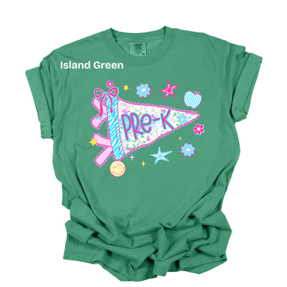 A green short-sleeve t-shirt with a colorful 'Pre-K' pennant graphic and the text 'Island Green' printed on the chest, displayed flat against a white background.