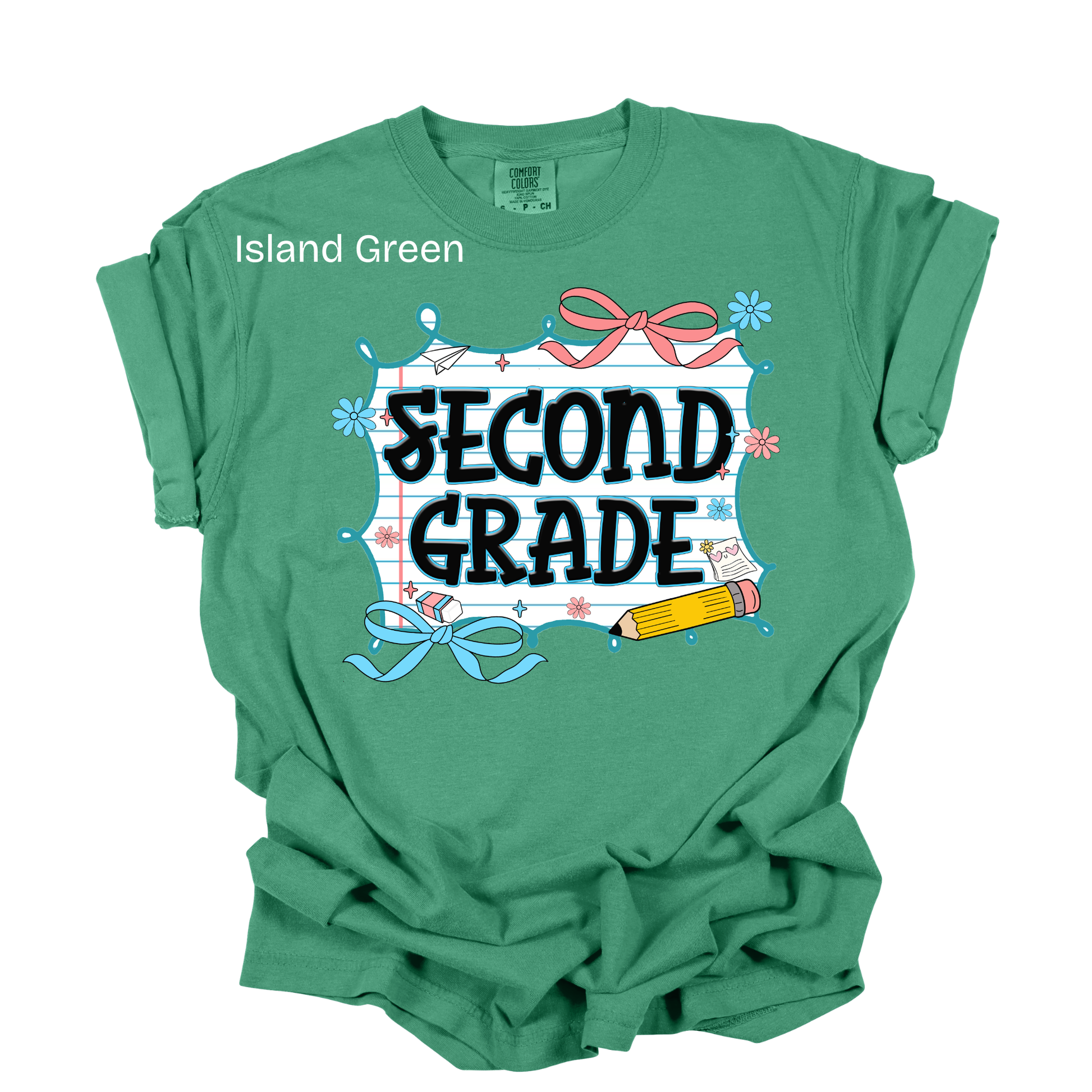 A green short-sleeve t-shirt with a 'SECOND GRADE' graphic on the front, featuring school-themed illustrations like a pencil, ribbon, and chalkboard. The text 'Island Green' is printed near the left shoulder.