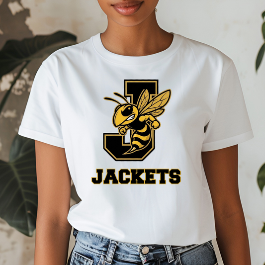 A woman wearing a white short-sleeve graphic T-shirt with a large yellow and black bee mascot and the word 'JACKETS' on the front, paired with blue jeans.