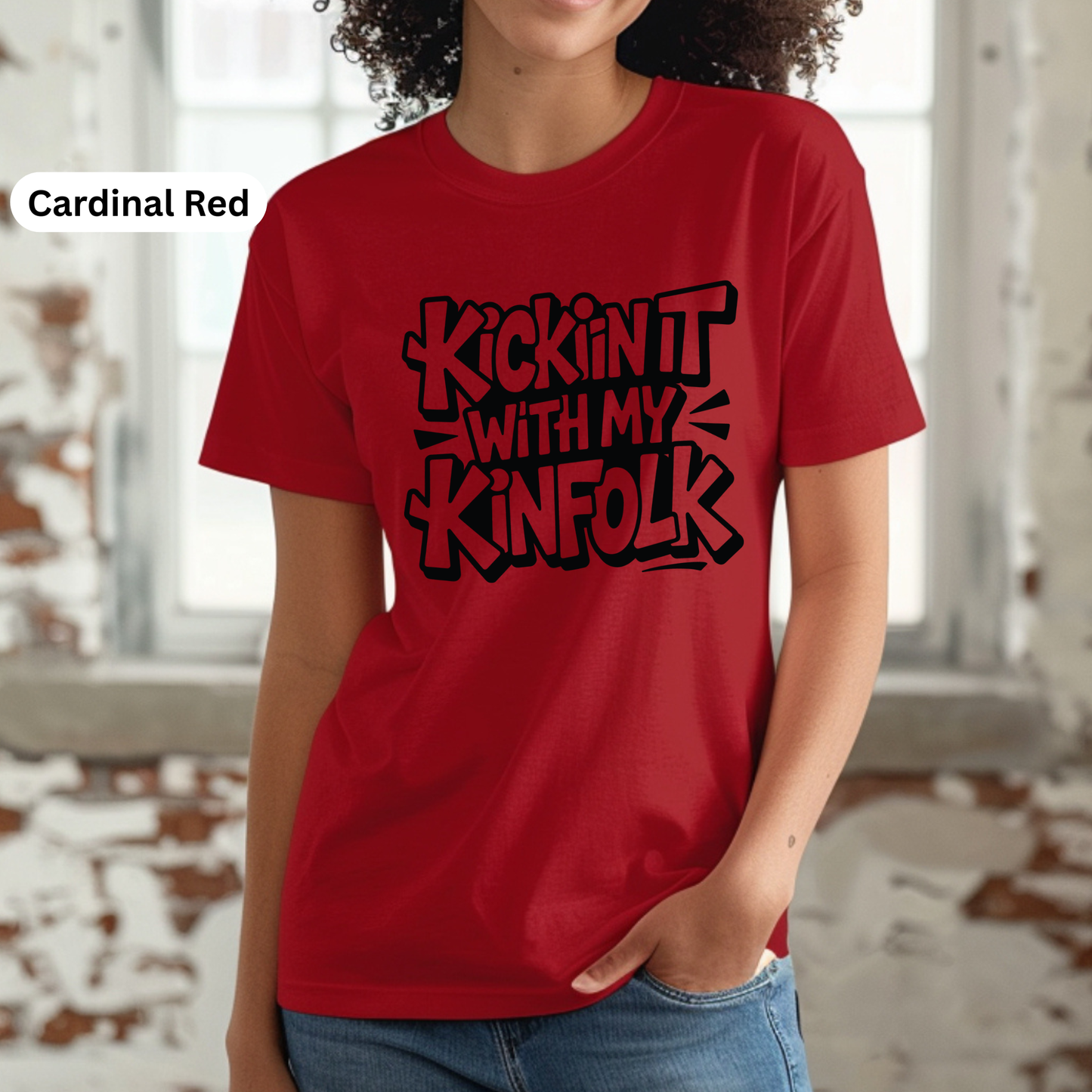 Person wearing a red t-shirt with black text in a casual setting
