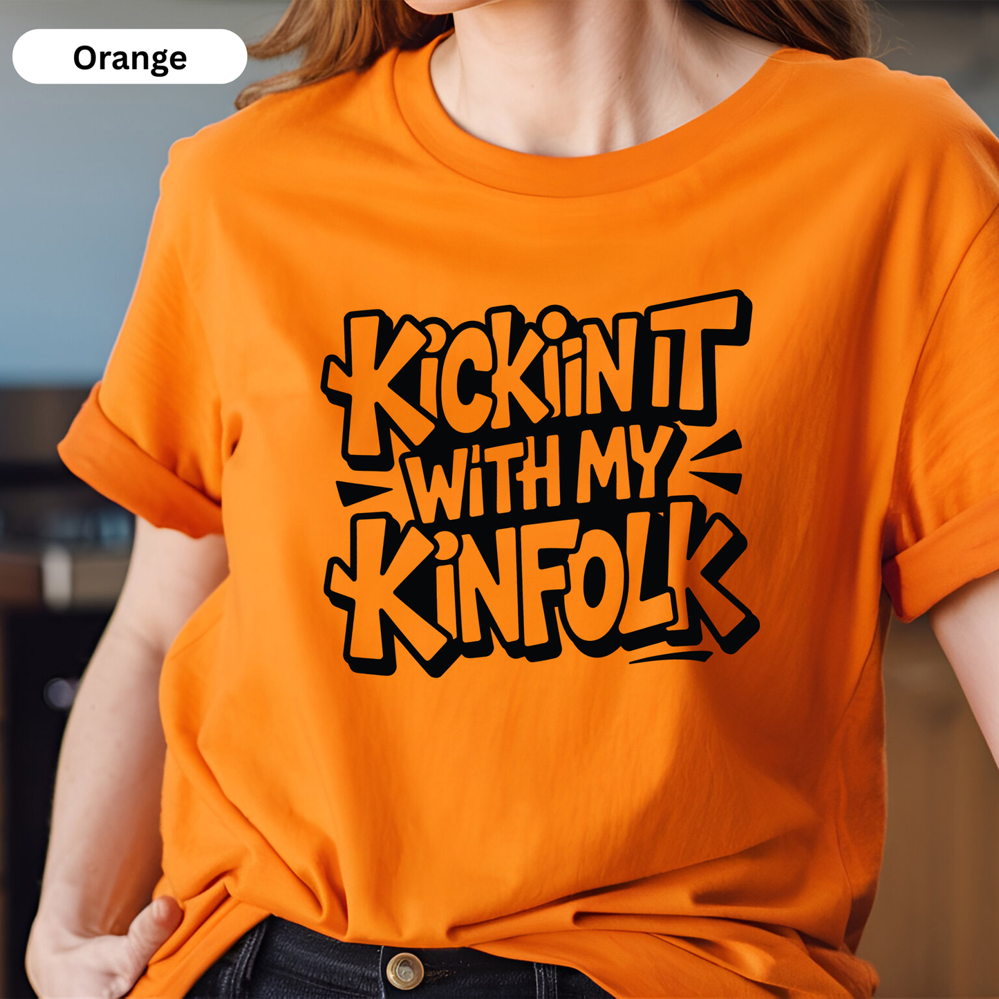 Person wearing an orange t-shirt with black text design.