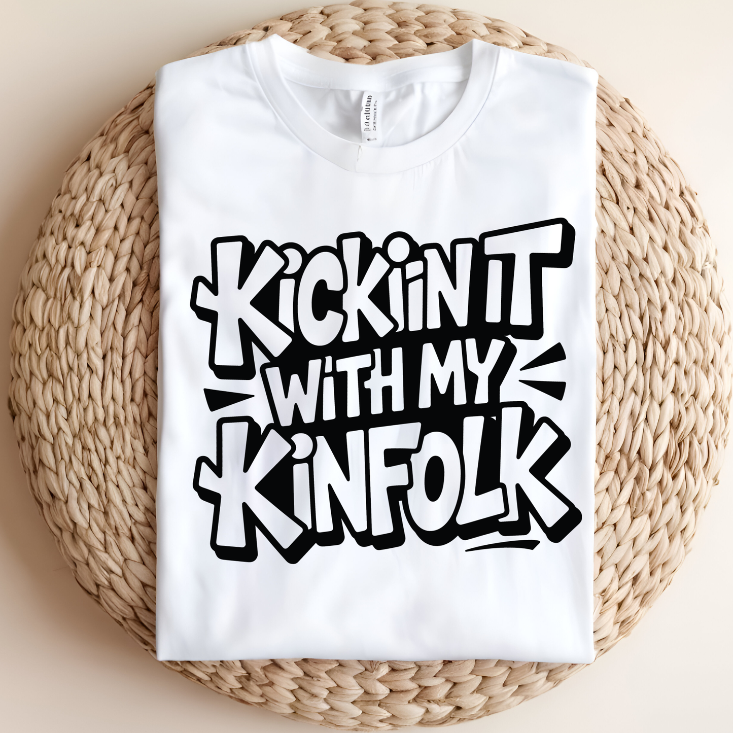 White t-shirt with black text on a woven mat