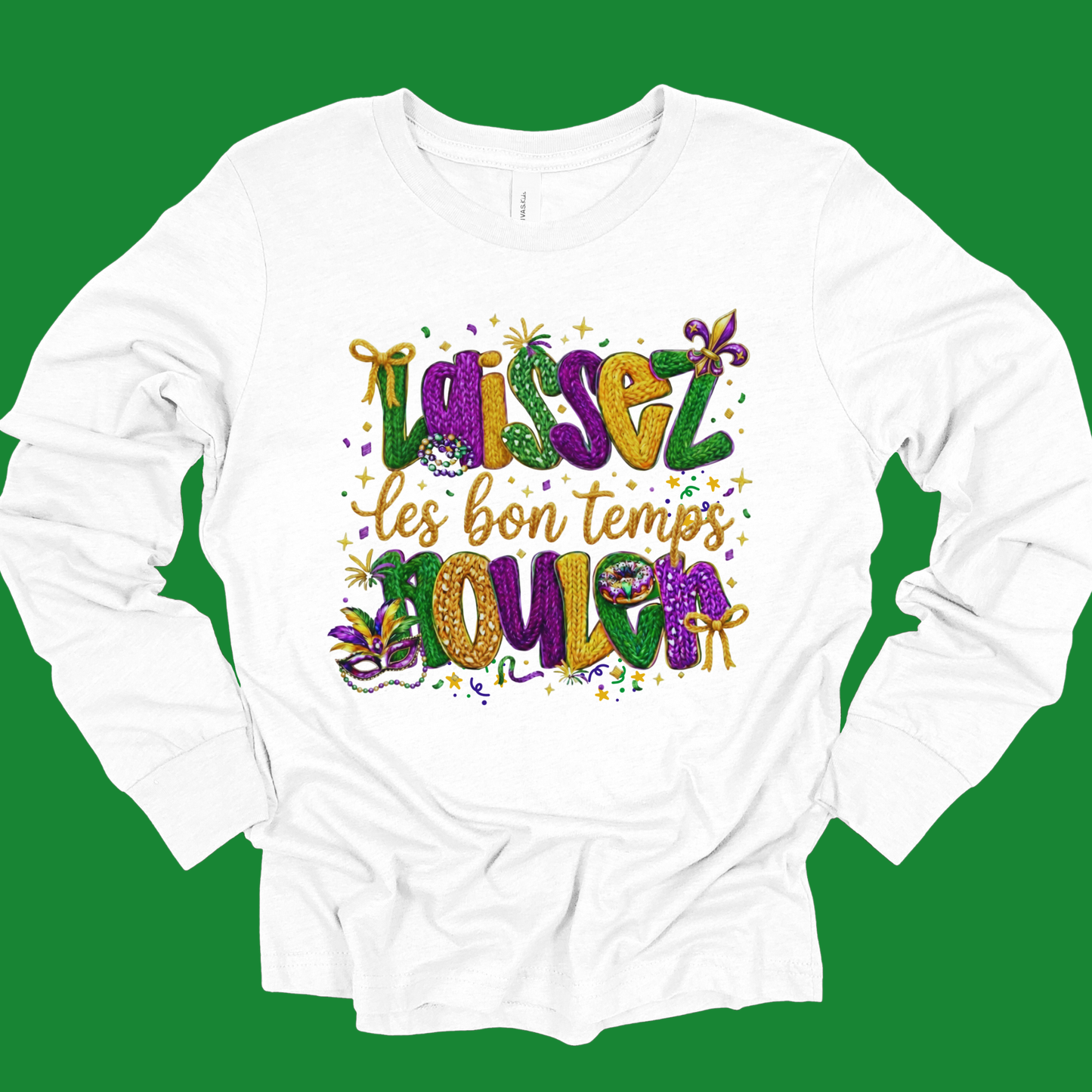 White long-sleeve shirt with colorful Mardi Gras-themed text on a green background