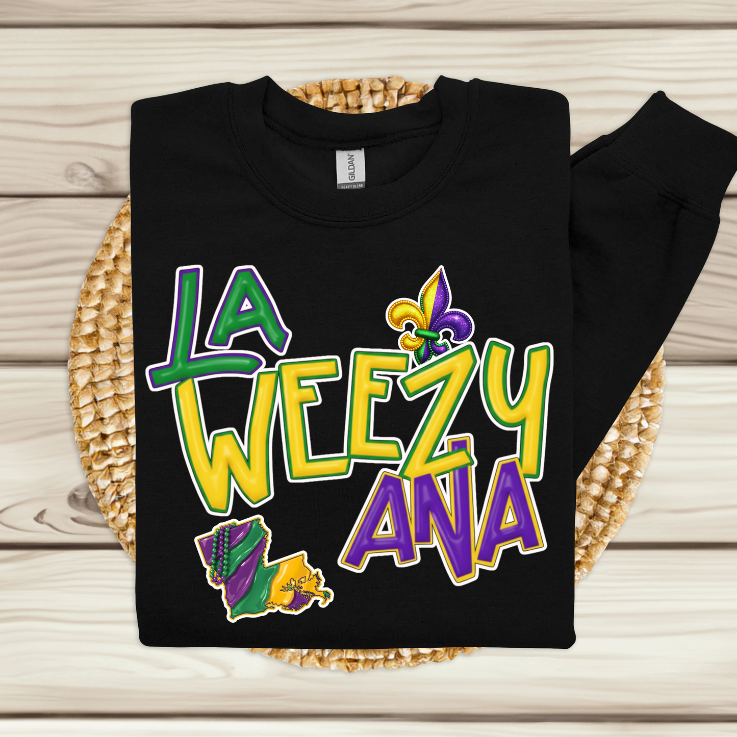 Black sweatshirt with colorful text and graphics on a woven mat