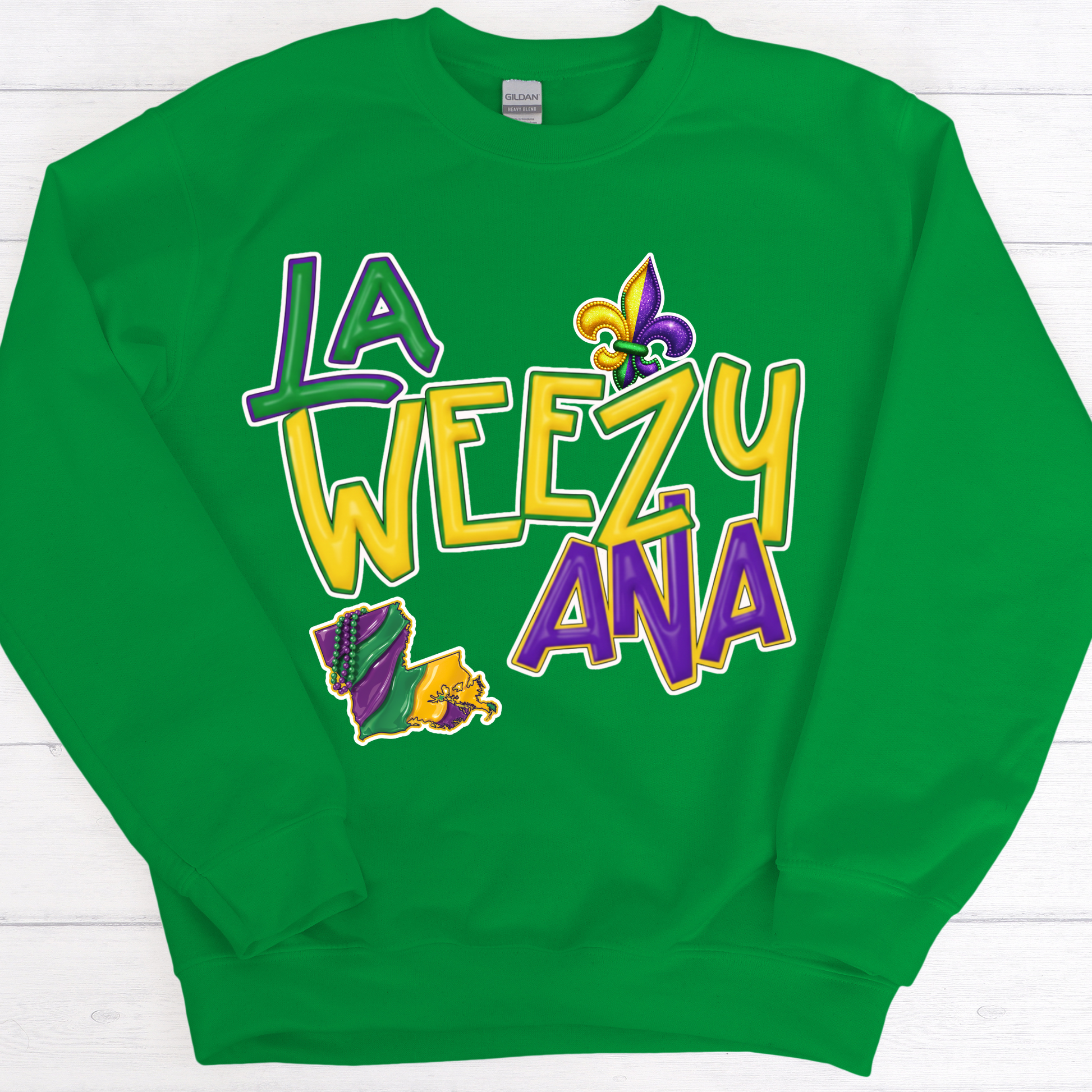 Green sweatshirt with 'La Weezy Ana' text and Mardi Gras-themed graphics on a white background