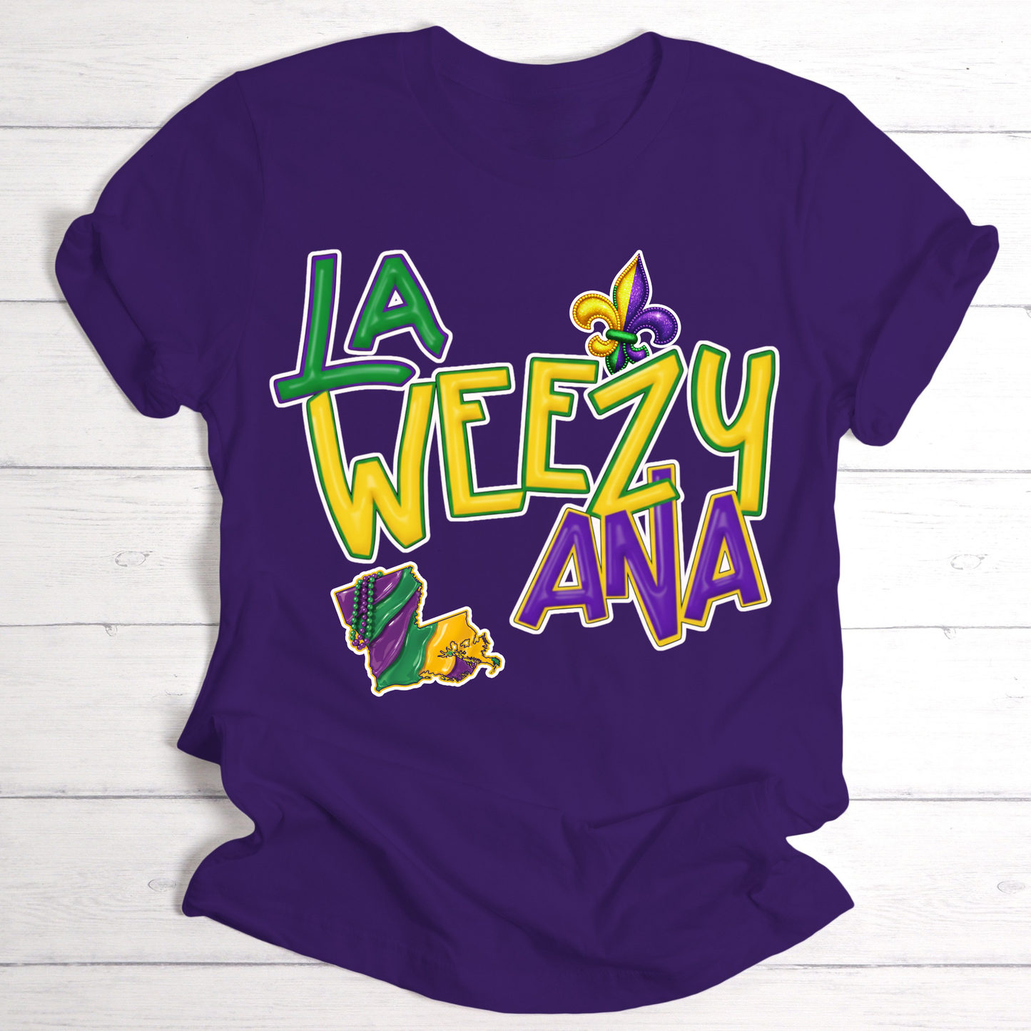 Purple t-shirt with colorful text and graphics on a white wooden background