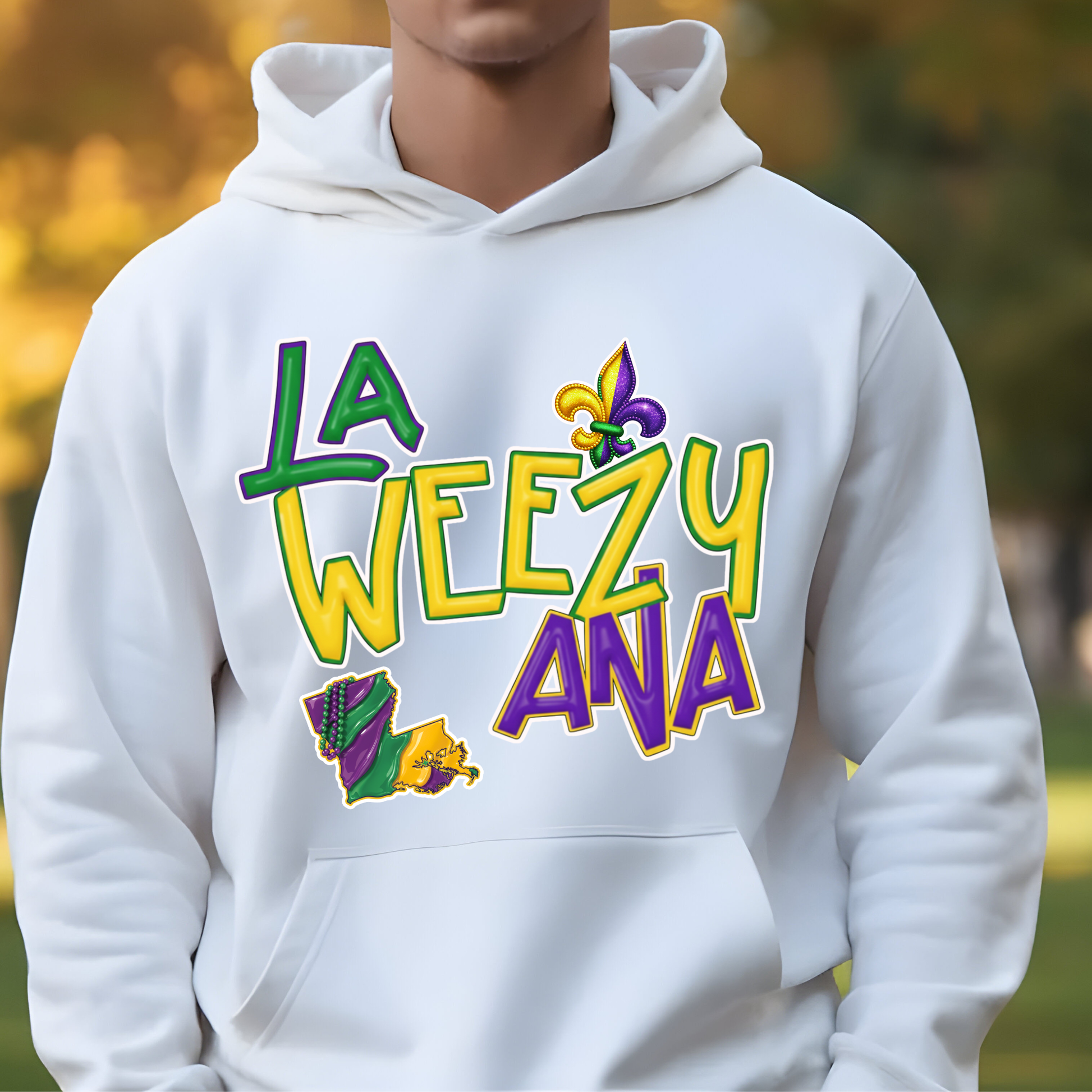 White hoodie with colorful text and graphics worn by a person outdoors.