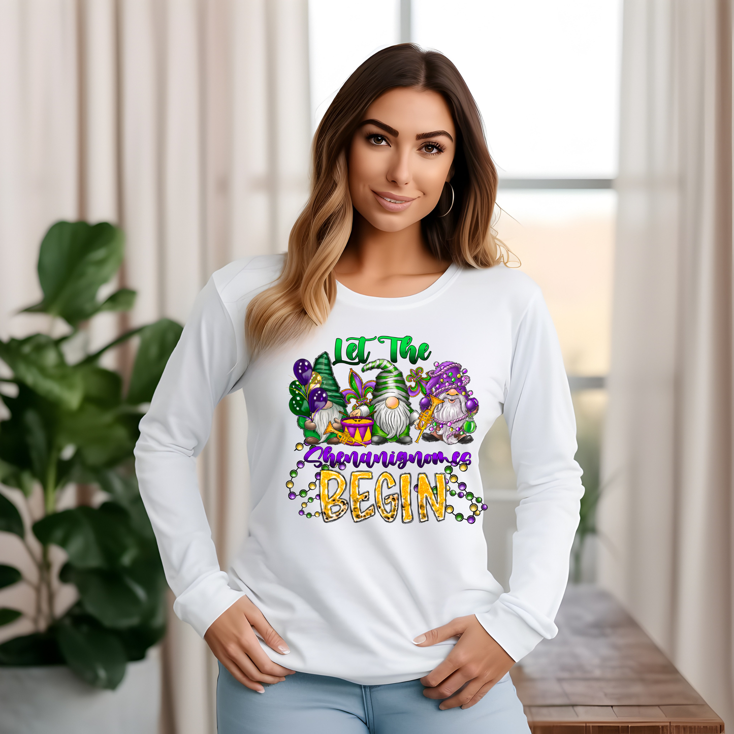Woman wearing a white long-sleeve shirt with a colorful graphic and text, standing indoors.