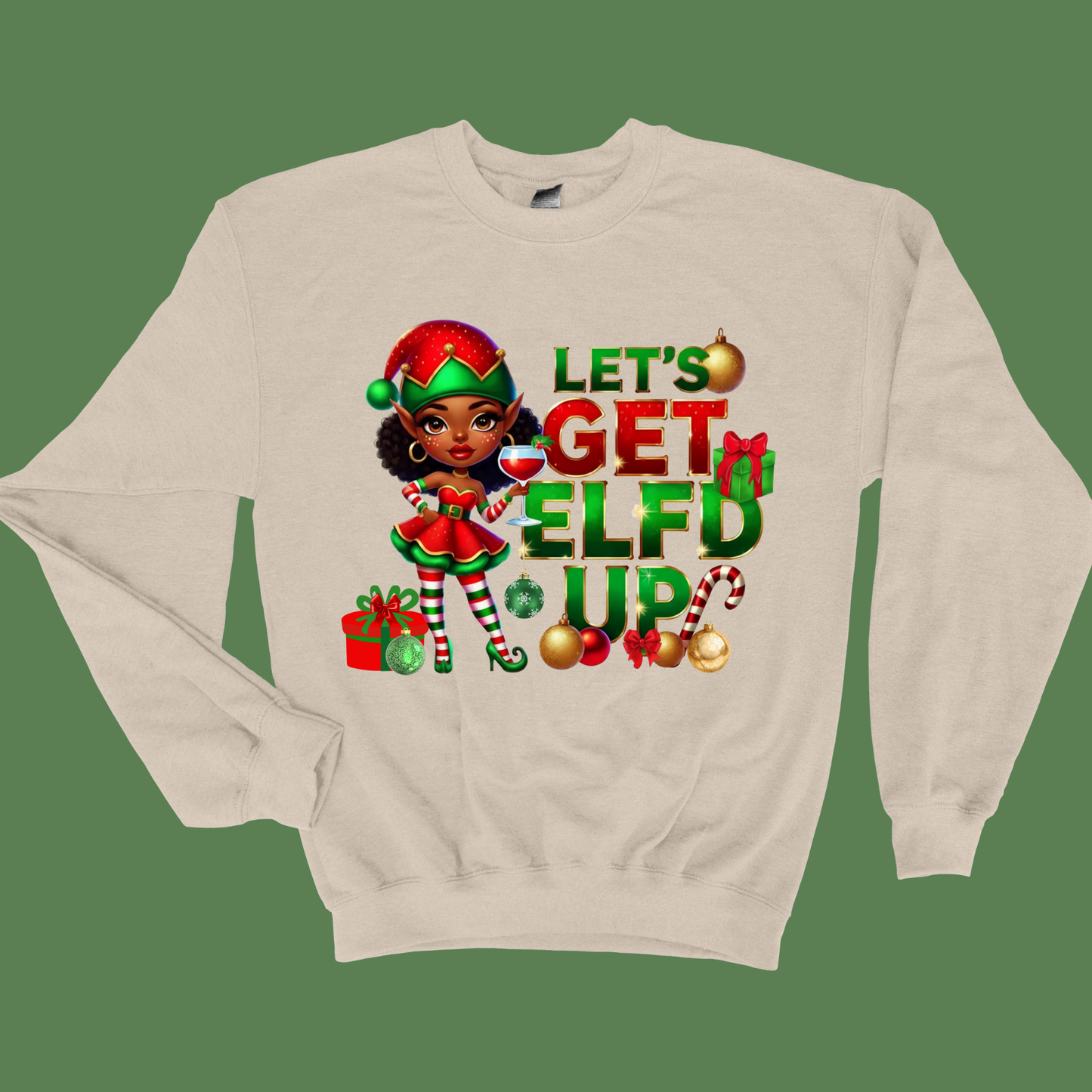 Beige sweatshirt with Christmas-themed design featuring an elf and text on a green background