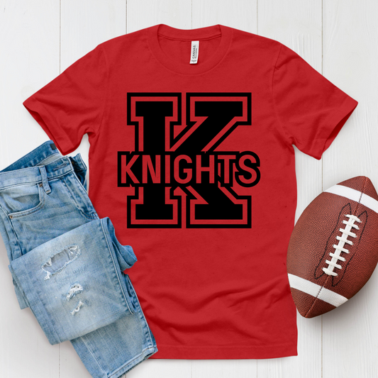 Red t-shirt with 'TV Knights' design, blue jeans, and football on a white wooden surface Knights School Spirit Shirt - Knights Logo: Loud & Proud Knights