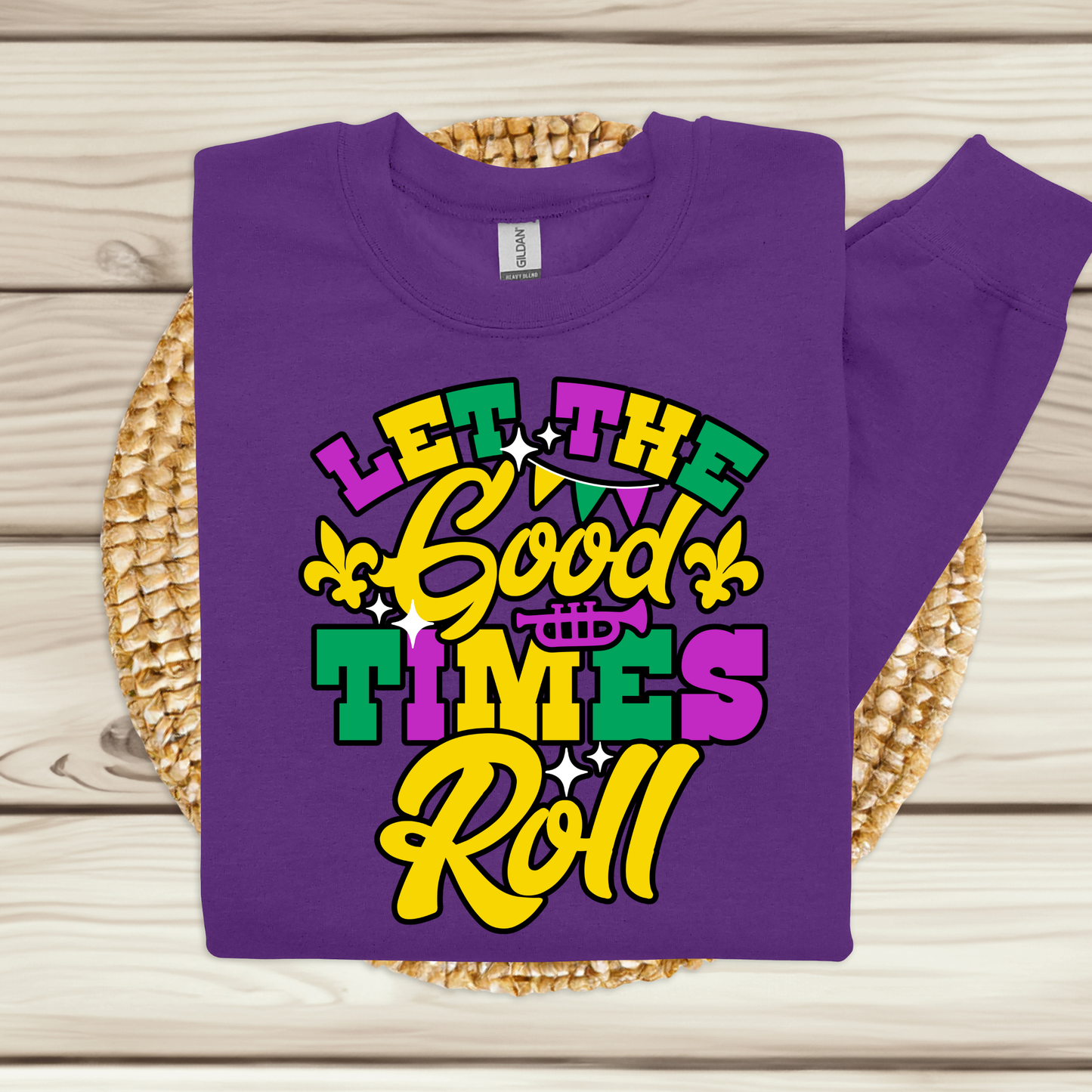 Purple t-shirt with colorful text design on a woven mat