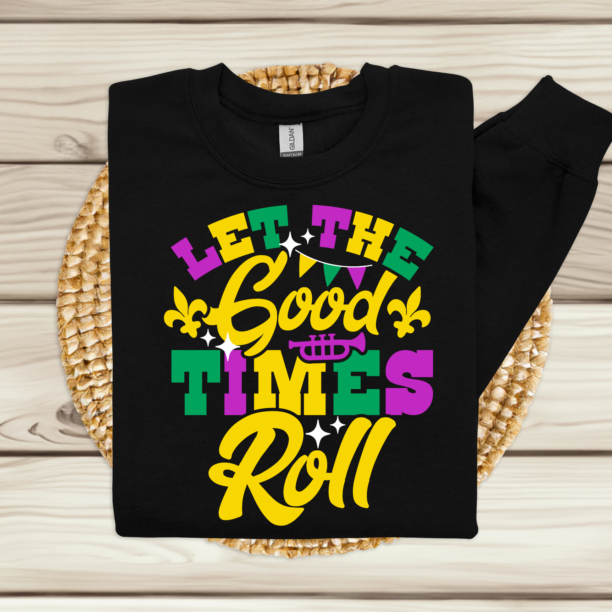 Black sweatshirt with colorful 'Let the Good Times Roll' text on a woven mat.