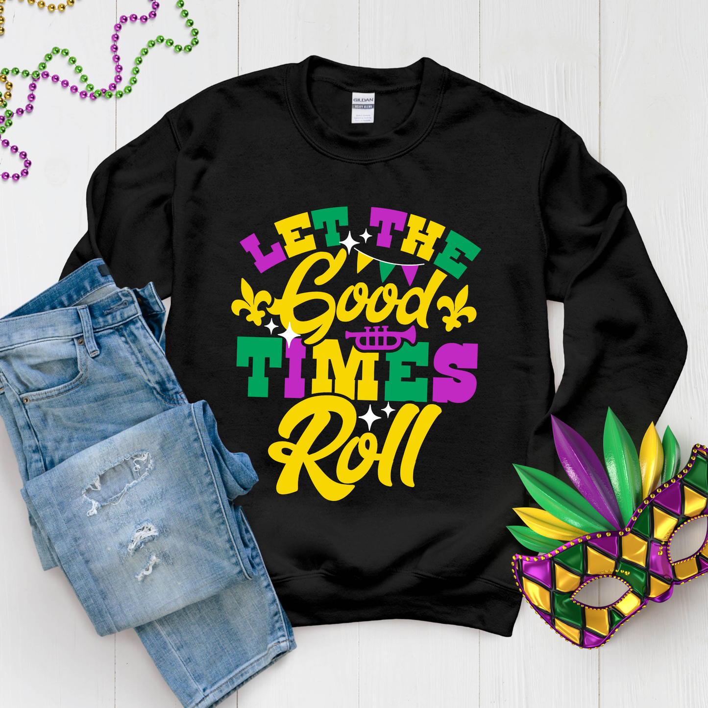 Black sweatshirt with 'Let the Good Times Roll' text, denim shorts, and Mardi Gras mask on a white background