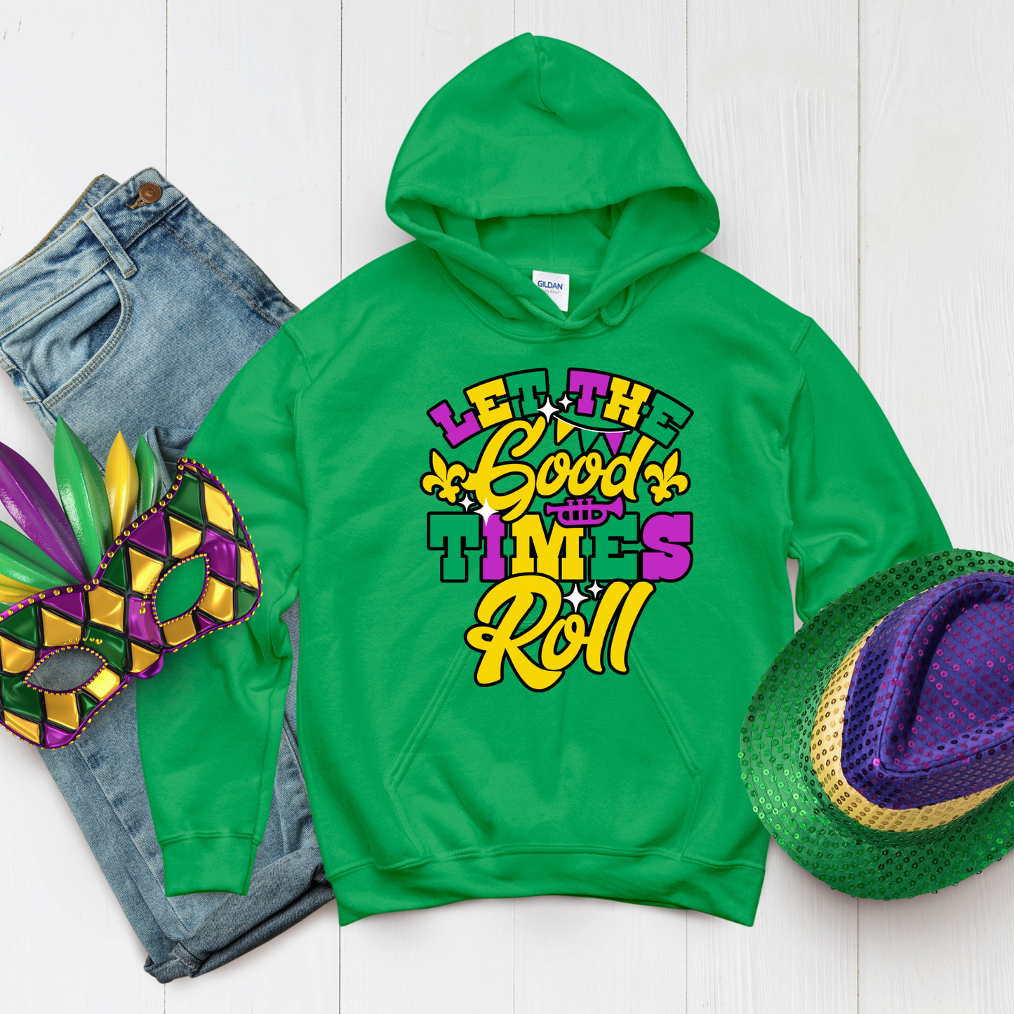 Green hoodie with 'Let the Good Times Roll' text, jeans, mask, and hat on a white background