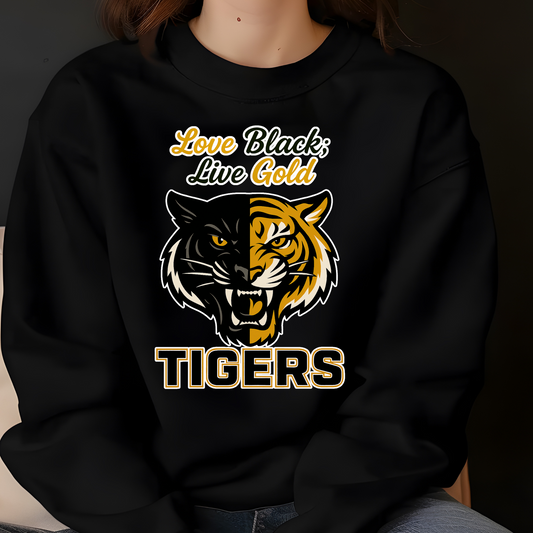 Black sweatshirt with tiger graphic and text 'Love Black, Live Gold TIGERS' on a dark background Grambling Tigers Sweater: Love Black; Live Gold Unisex Bold Crewneck Sweater