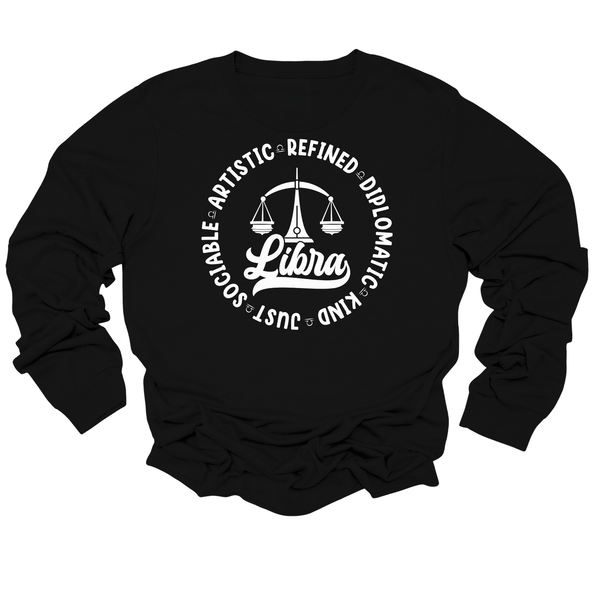 Woman wearing a white crewneck t-shirt featuring a black circular Libra zodiac graphic with a scales illustration, the word "Libra," and trait keywords like artistic, refined, diplomatic, kind, just, and sociable.