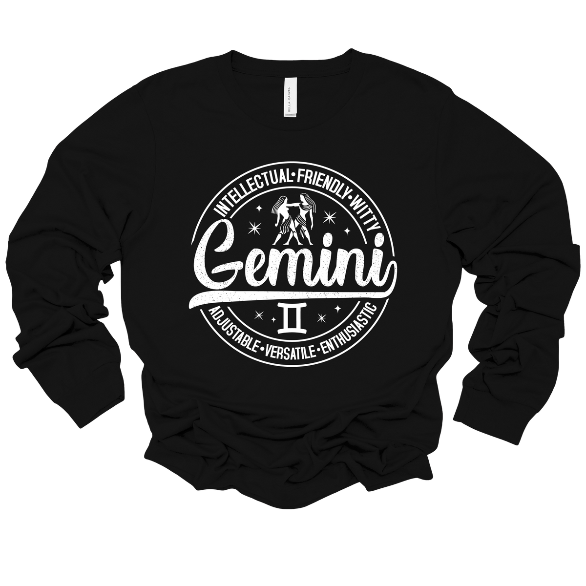 black t-shirt laid flat, featuring a circular white Gemini zodiac graphic with the twins illustration, the word "Gemini," and trait keywords like intellectual, friendly, witty, enthusiastic, versatile, and adjustable.