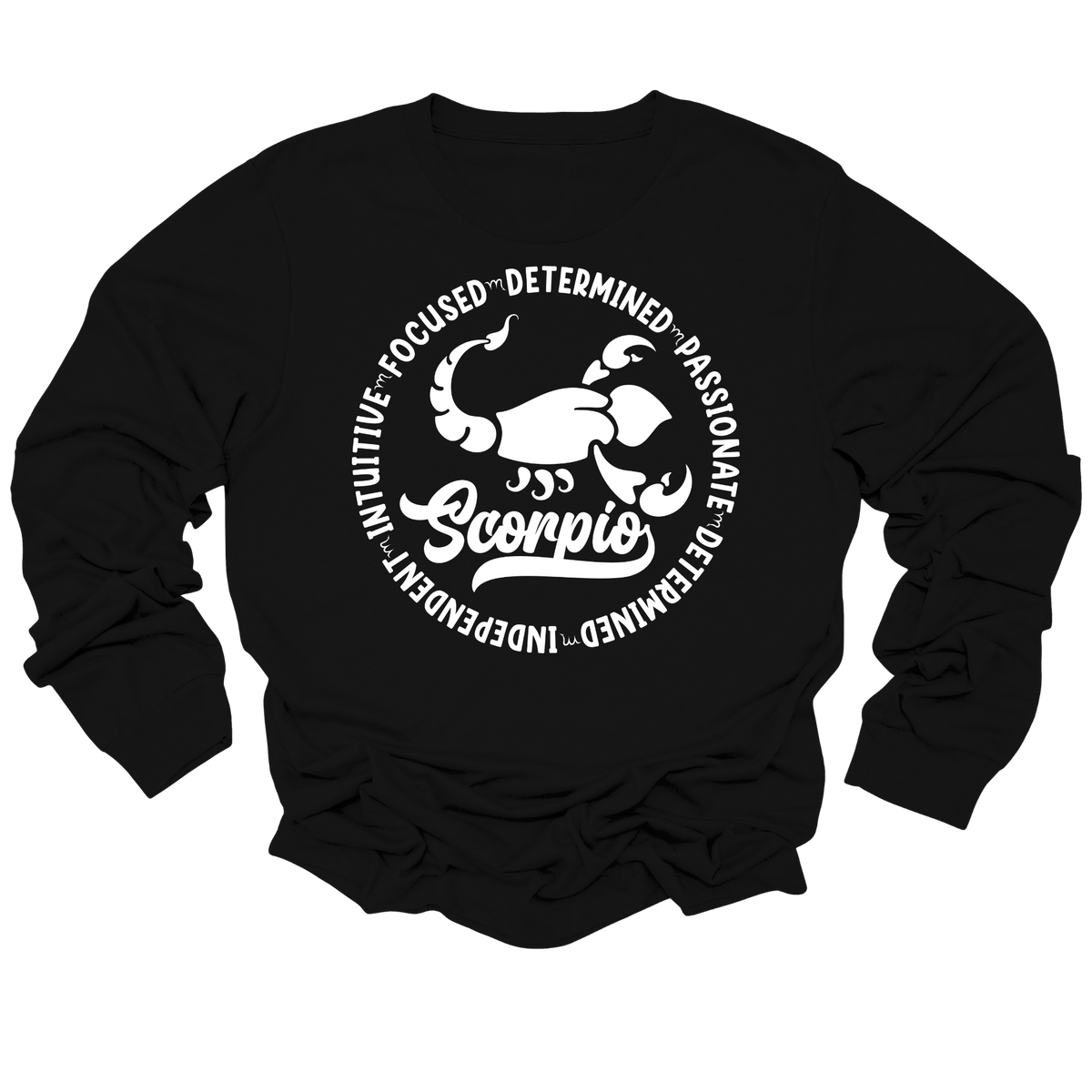 Woman wearing a black crewneck sweatshirt featuring a white circular Scorpio zodiac graphic with a scorpion illustration, the word "Scorpio," and trait keywords like intuitive, focused, determined, passionate, and independent.