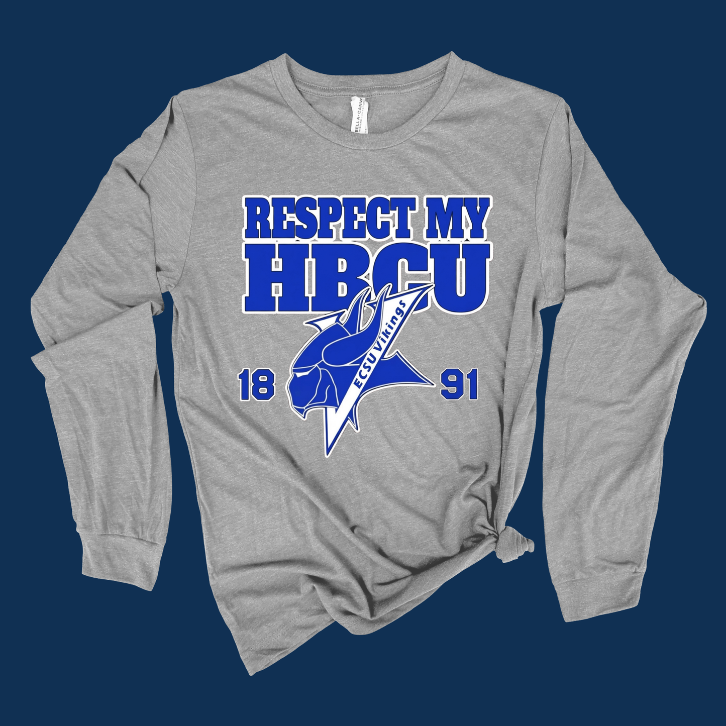 A heather gray long-sleeve t-shirt with a blue and white graphic print on the front reading 'RESPECT MY HBCU' and '1891', featuring a blue horse mascot logo. The shirt is styled with a knot at the bottom hem and is displayed against a solid dark blue background.