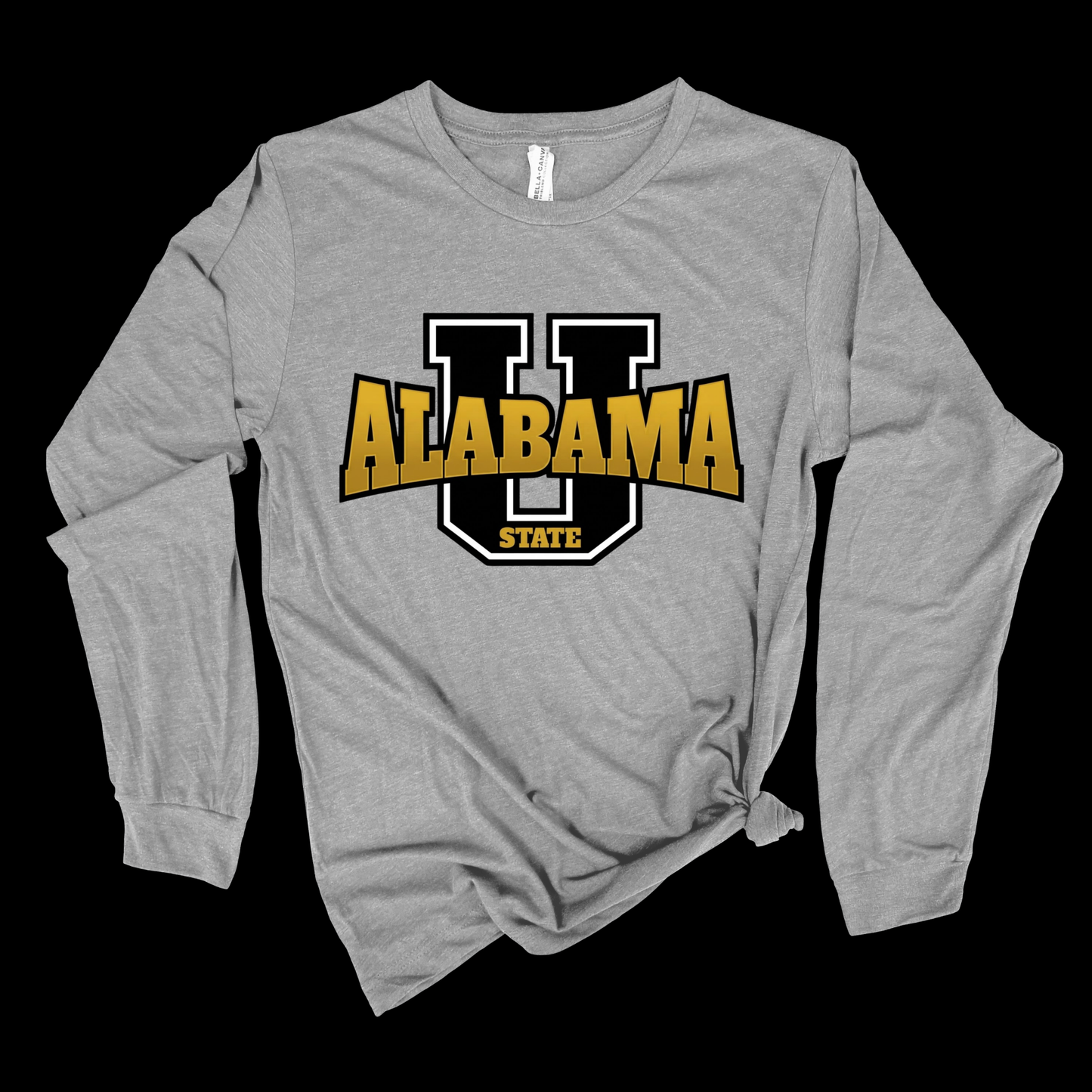 A heather gray long-sleeve t-shirt with a knotted hem, featuring a large graphic on the chest of a black and white block 'U' outlined with gold and black 'ALABAMA STATE' lettering, displayed against a solid black background.
