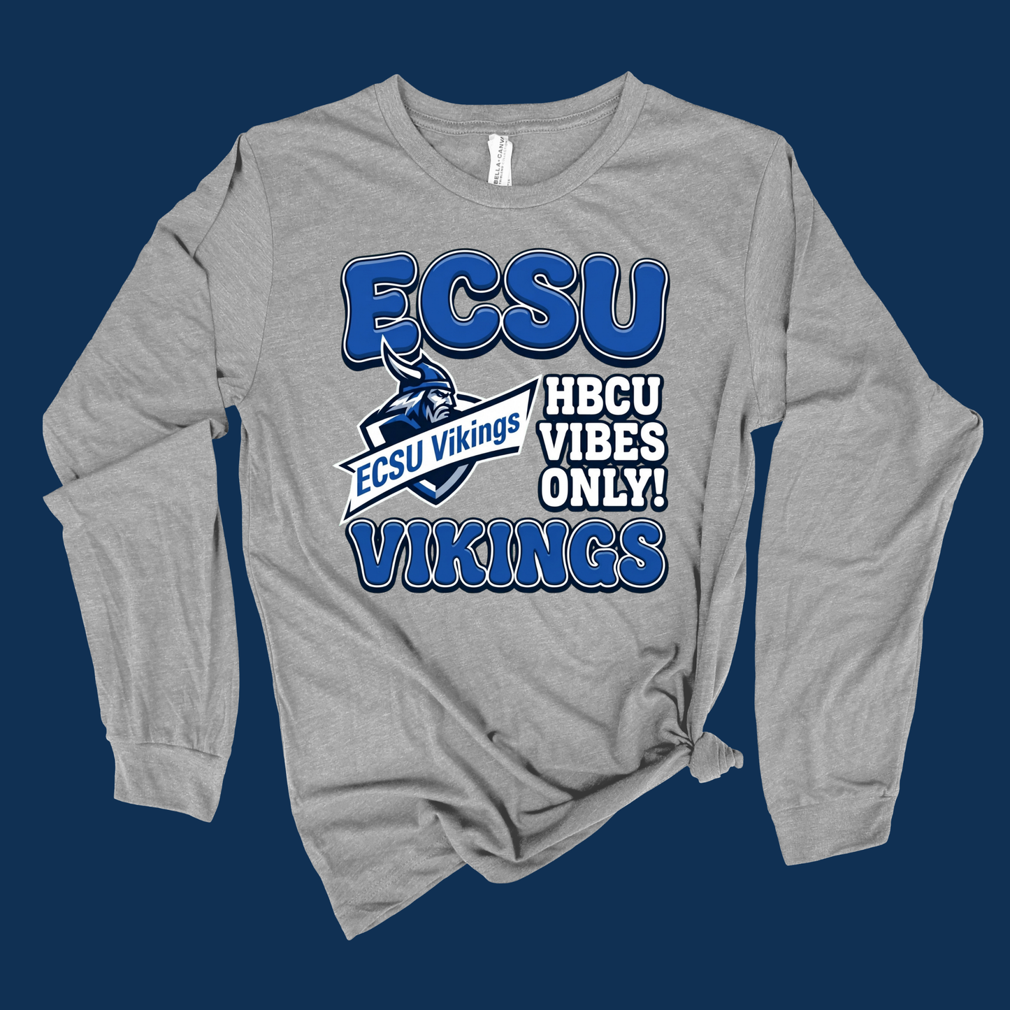 A heather gray long-sleeve t-shirt with a blue graphic print reading 'ELIZABETH 1891 CITY UNIVERSITY' on the front, styled with a knot at the bottom hem against a dark blue background.