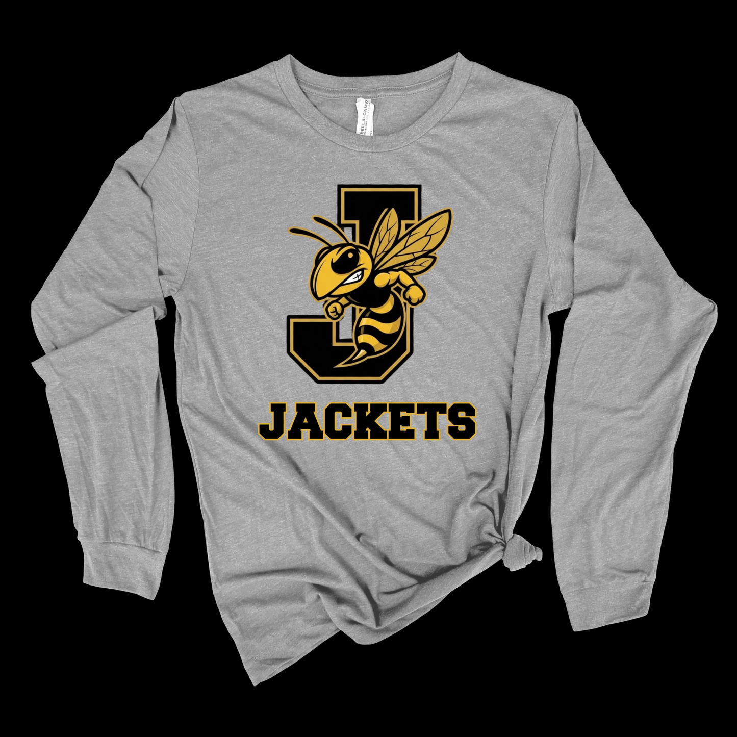 A heather gray long-sleeve t-shirt with a black and yellow 'J' and bee graphic, featuring the text 'JACKETS' printed below it. The shirt is styled with a knot at the bottom hem and is photographed against a solid black background.