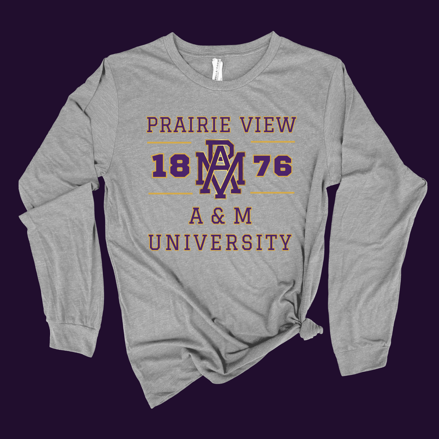 A heather gray long-sleeve t-shirt with a distressed purple and gold graphic reading 'PRAIRIE VIEW 18 PAV 76 A&M UNIVERSITY', shown flat against a dark purple background.