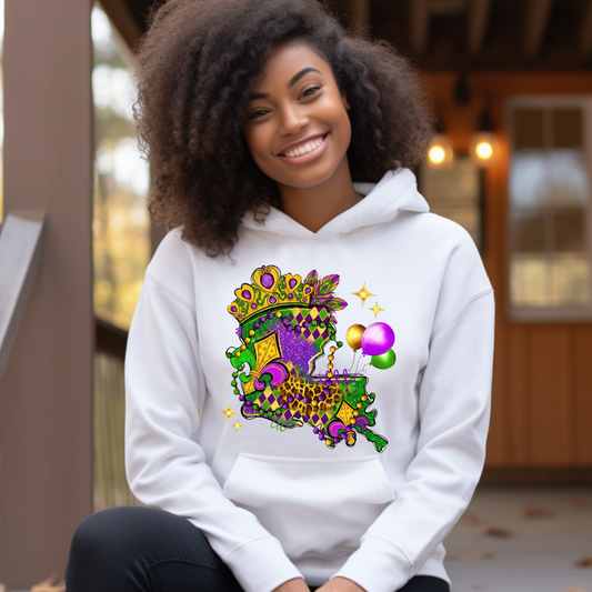 Person wearing a white hoodie with a colorful design, sitting outdoors.