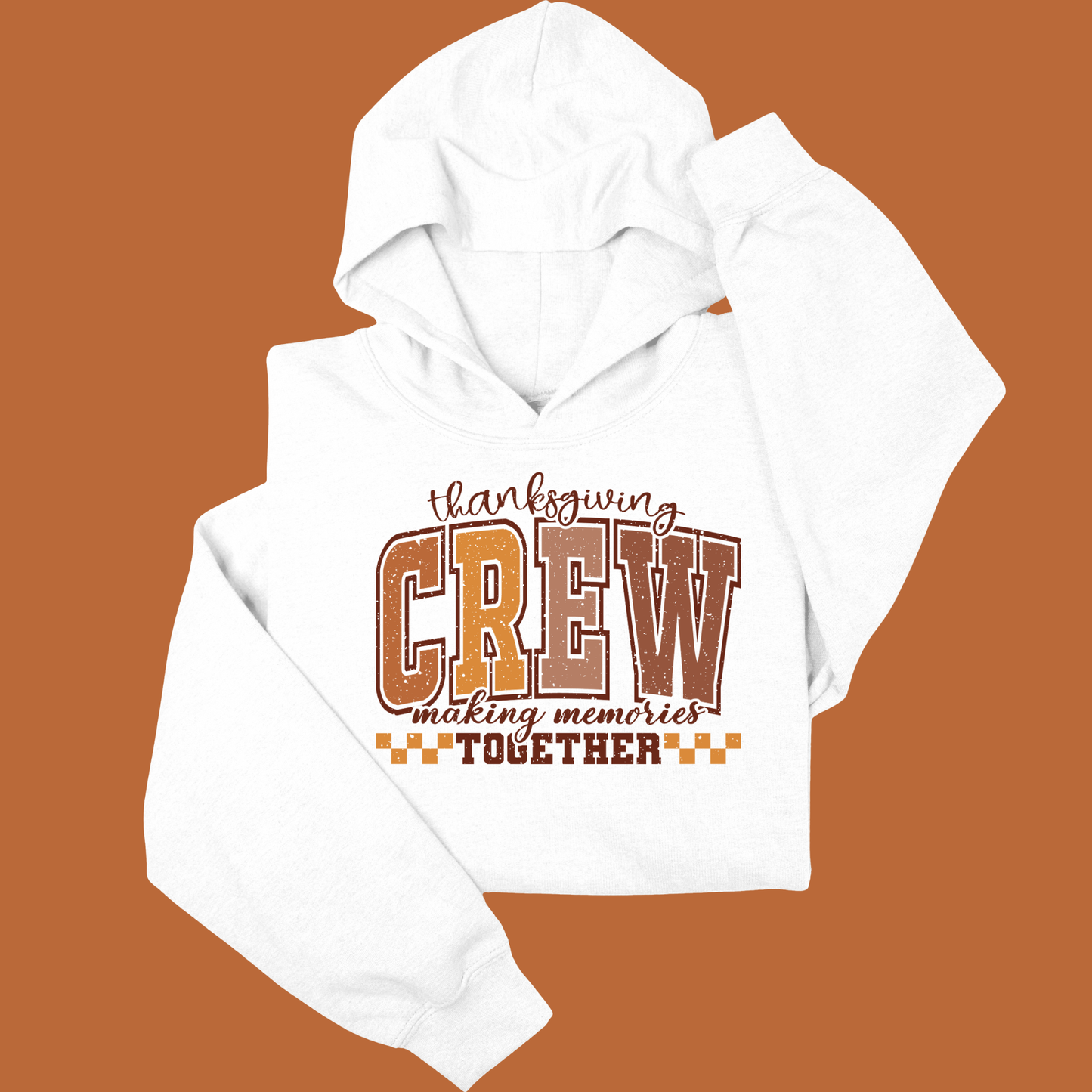 White hoodie with 'Thanksgiving Crew making memories together' text on a brown background